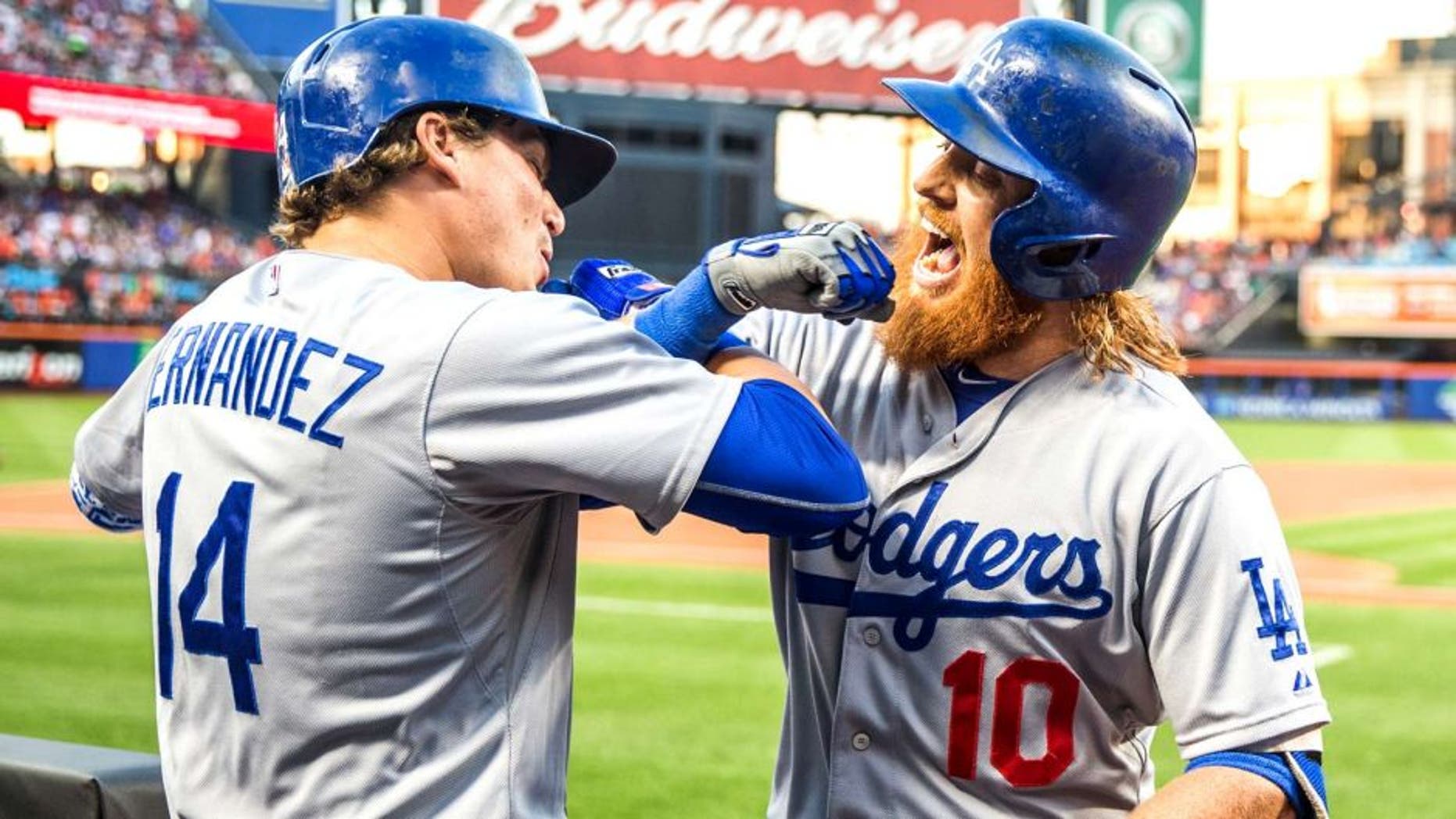 NEW YORK - JULY 24: Justin Turner #10 of the Los Angeles Dodgers fist bumps Enrique Hernandez #14 after hitting a home run during the game against the New York Mets at Citi Field on July 24, 2015 in the Queens borough of New York City. (Photo by Rob Tringali/SportsChrome/Getty Images)