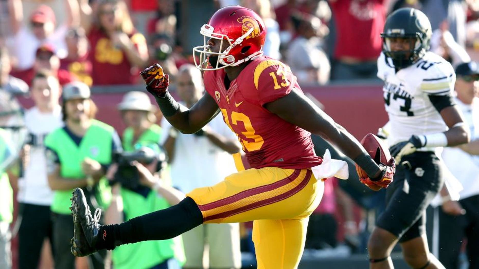 LOS ANGELES, CA - OCTOBER 18: Tight end Bryce Dixon #13 of the USC Trojans high steps in the end zone after scoring on a nine yard touchdown pass play in the second quarter against the Colorado Buffaloes at Los Angeles Memorial Coliseum on October 18, 2014 in Los Angeles, California. (Photo by Stephen Dunn/Getty Images)