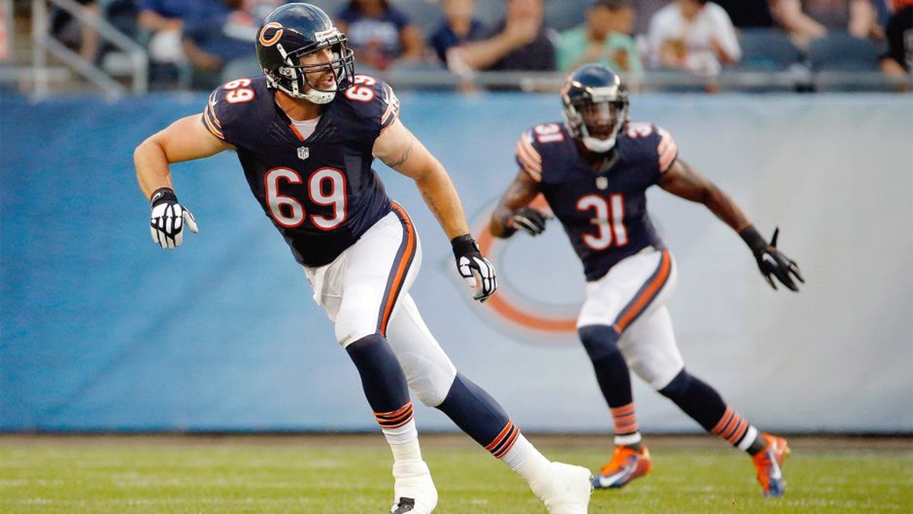 Aug 13, 2015; Chicago, IL, USA; Chicago Bears linebacker Jared Allen (69) and defensive back Antrel Rolle (31) follow the play during the first quarter against the Miami Dolphins in a preseason NFL football game at Soldier Field. Mandatory Credit: Jon Durr-USA TODAY Sports