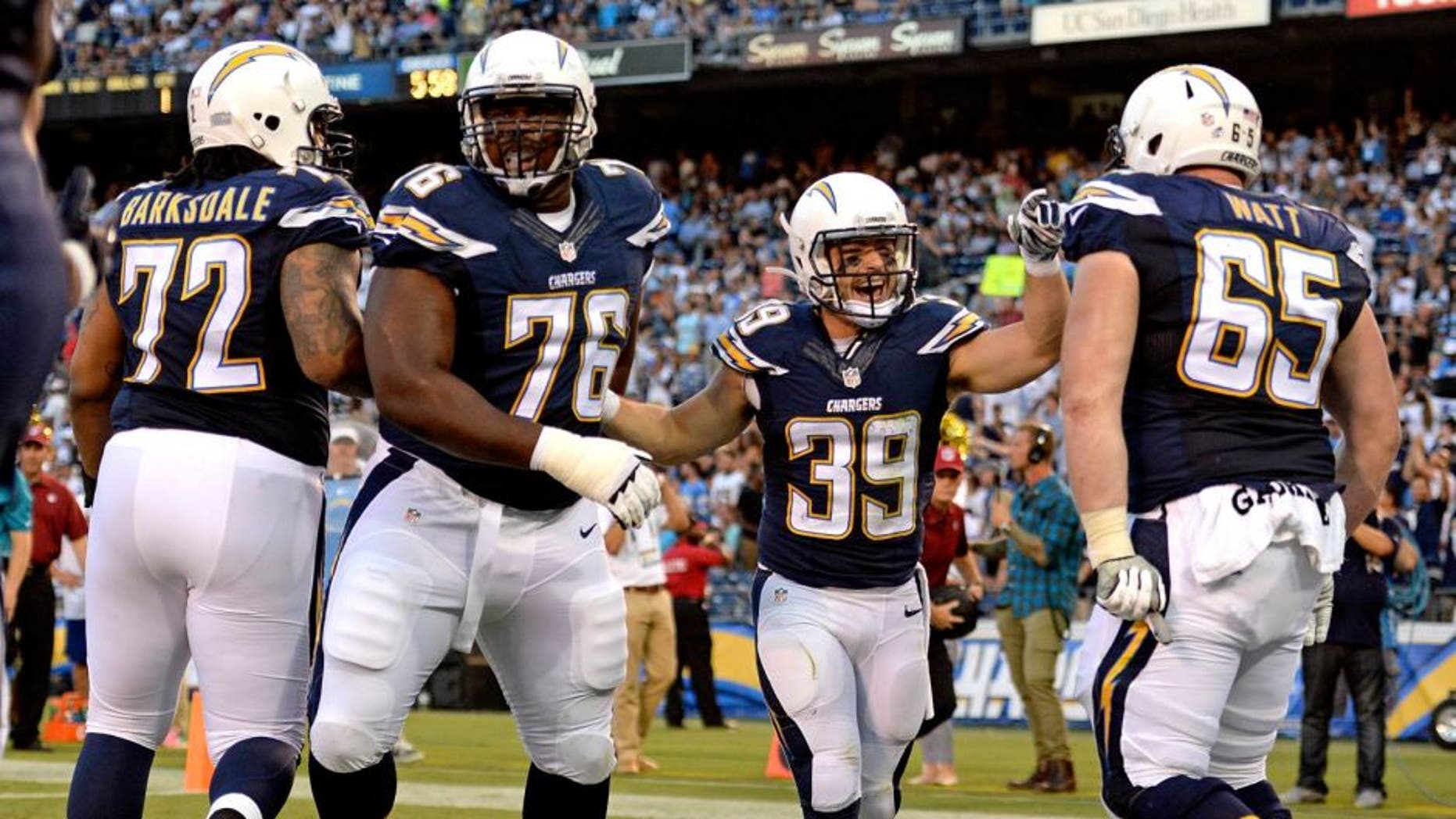 Aug 13, 2015; San Diego, CA, USA; San Diego Chargers running back Danny Woodhead (39) is congratulated by teammates after running for a touchdown during the first quarter against the Dallas Cowboys in a preseason NFL football game at Qualcomm Stadium. Mandatory Credit: Jake Roth-USA TODAY Sports
