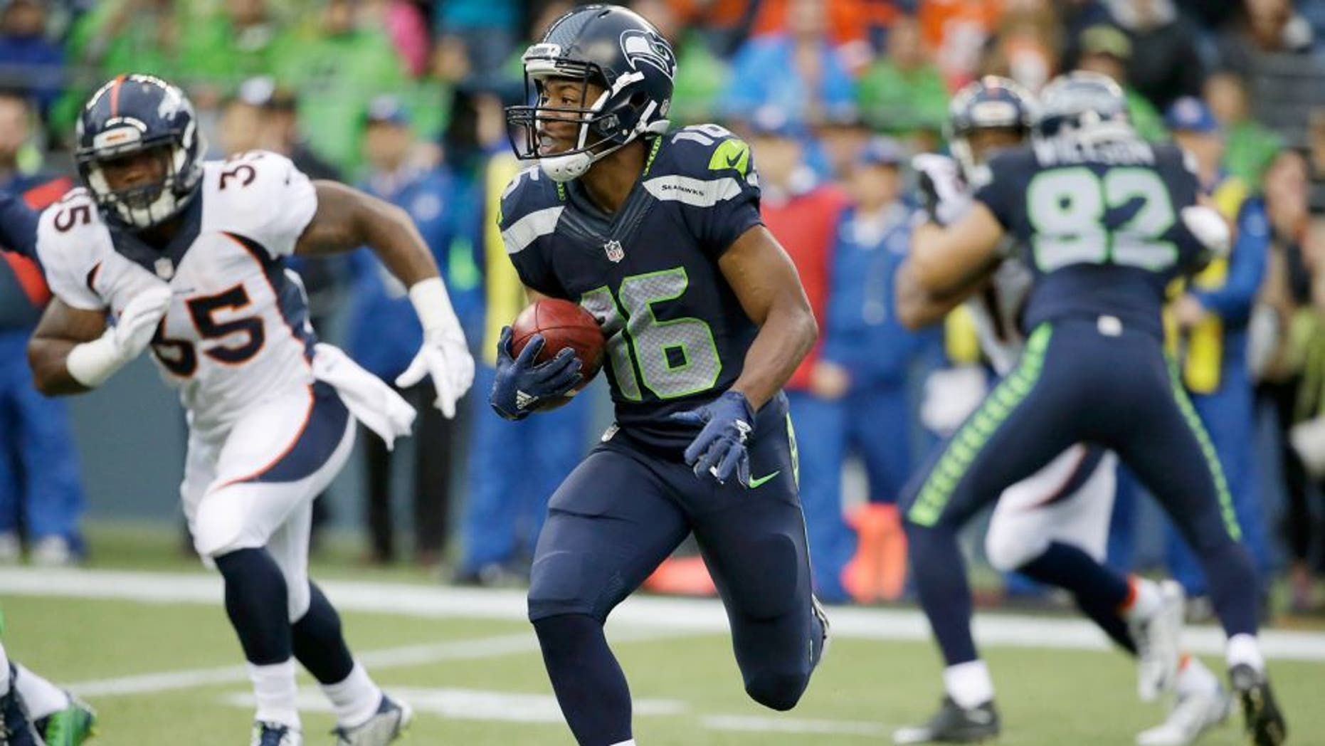 Seattle Seahawks' Tyler Lockett returns a kickoff 103 yards for a touchdown against the Denver Broncos during the first half of a preseason NFL football game, Friday, Aug. 14, 2015, in Seattle. (AP Photo/Elaine Thompson)