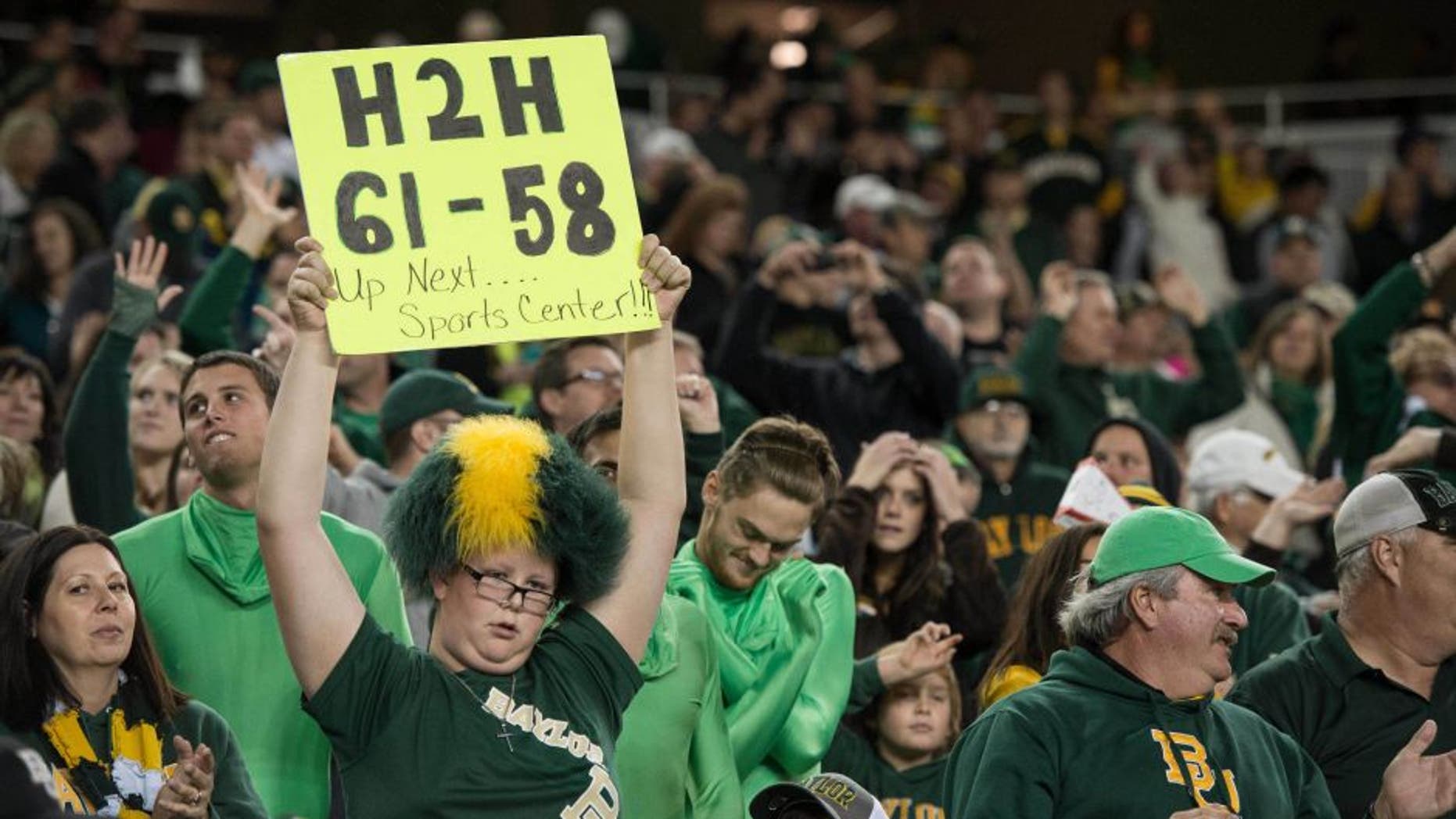 Dec 6, 2014; Waco, TX, USA; A Baylor Bears fan holds up a sign with the October score of the Bears game against the TCU Horned Frogs during the second half of the game between the Bears and the Kansas State Wildcats at McLane Stadium. The Bears defeated the Wildcats 38-27. Mandatory Credit: Jerome Miron-USA TODAY Sports