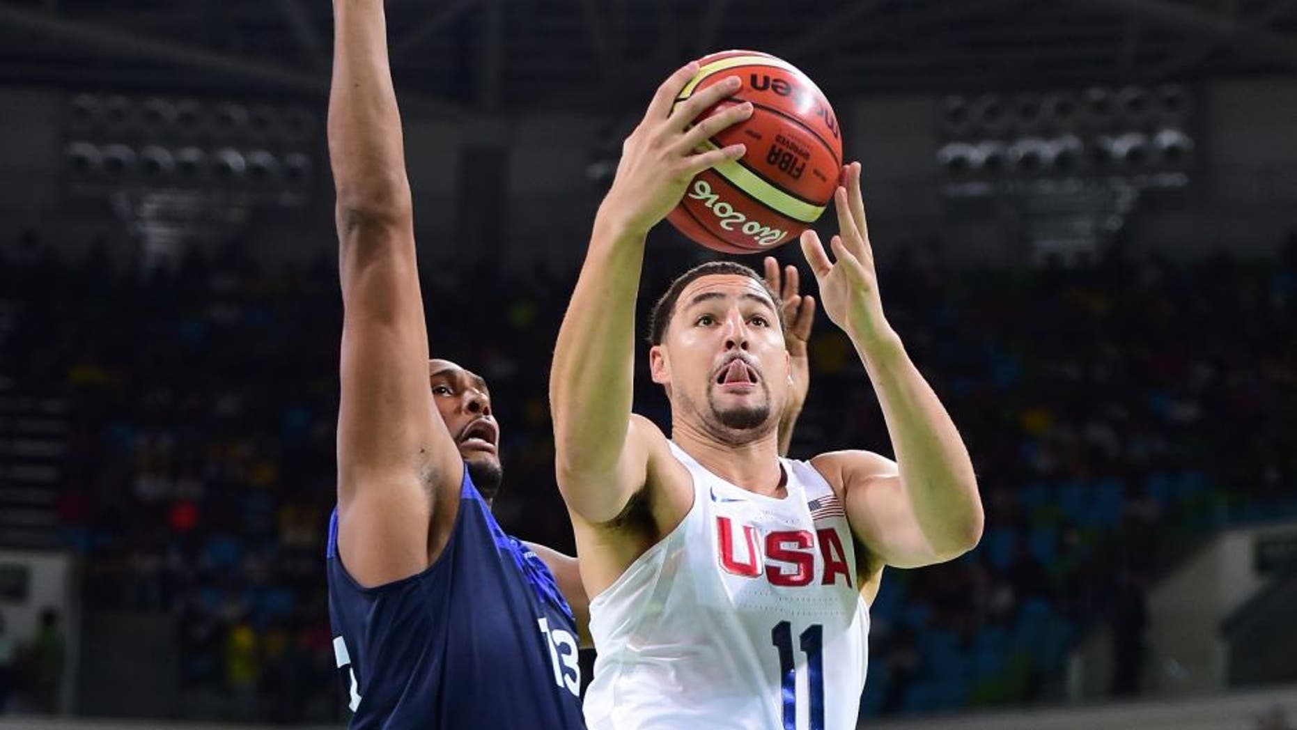 RIO DE JANEIRO, BRAZIL - AUGUST 14: Klay Thompson #11 of United States shoots past Boris Diaw #13 of France during a Men's Preliminary Round Group A game between the United States and France on Day 9 of the Rio 2016 Olympic Games at Carioca Arena 1 on August 14, 2016 in Rio de Janeiro, Brazil. (Photo by Harry How/Getty Images)