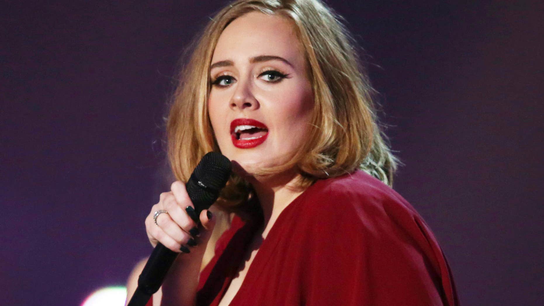 FILE - In this Feb. 24, 2016 file photo shows Adele onstage at the Brit Awards 2016 at the 02 Arena in London.