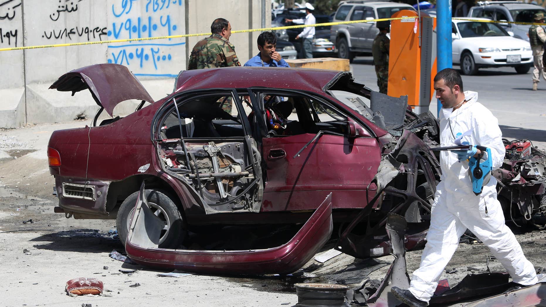 Aug. 15, 2016: An Afghan security personnel inspects the site of an explosion near the U.S. Embassy in Kabul, Afghanistan.