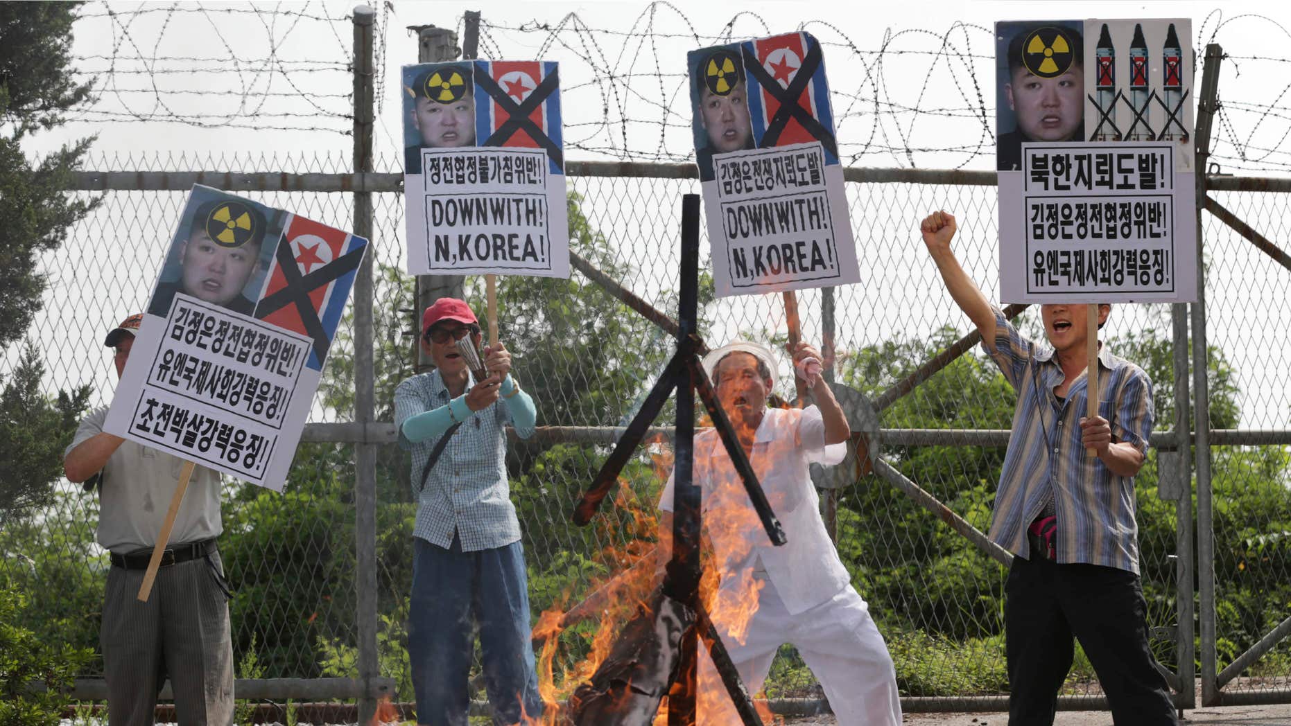 Aug. 11, 2015: Members of South Korean conservative group shout slogans after burning an effigy of North Korean leader Kim Jong Un and North Korean flags during a rally denouncing the North Korea at the Imjingak Pavilion near the border village of Panmunjom in Paju, South Korea.