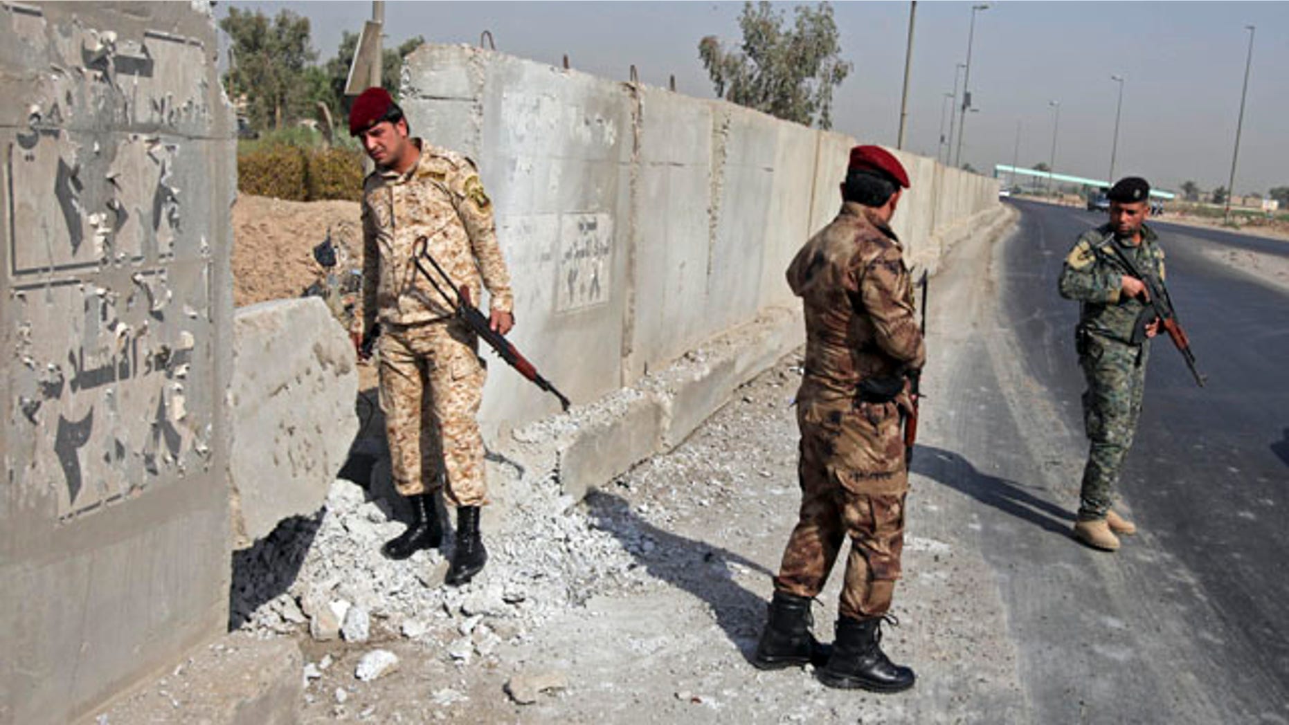 Aug. 15: Iraqi army soldiers secure the scene of a roadside bomb attack in Baghdad, Iraq.