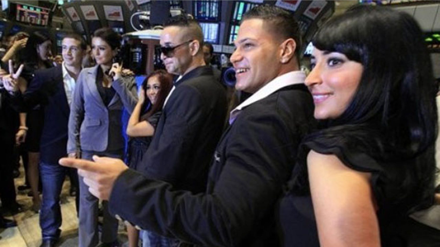 July 27: Cast members of MTV's "Jersey Shore" reality series pose for photos after ringing the opening bell of the New York Stock Exchange. They are, from left: Vinny Guadagnino; Jenni "J-Woww" Farley; Nicole "Snooki" Polizzi; Michael "The Situation" Sorrentino; Ronnie Ortiz; Angelina "Jolie" Pivarnick. (AP Photo/Richard Drew)