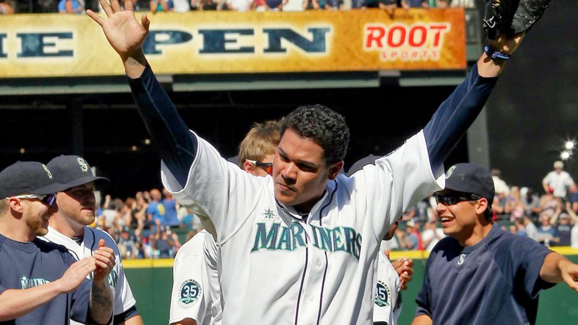 SEATTLE, WA - AUGUST 15: Starting pitcher Felix Hernandez #34 of the Seattle Mariners celebrates with teammates after throwing a perfect game to defeat the Tampa Bay Rays 1-0 at Safeco Field on August 15, 2012 in Seattle, Washington. It was the 23rd perfect game in Major League Baseball history. (Photo by Otto Greule Jr/Getty Images)