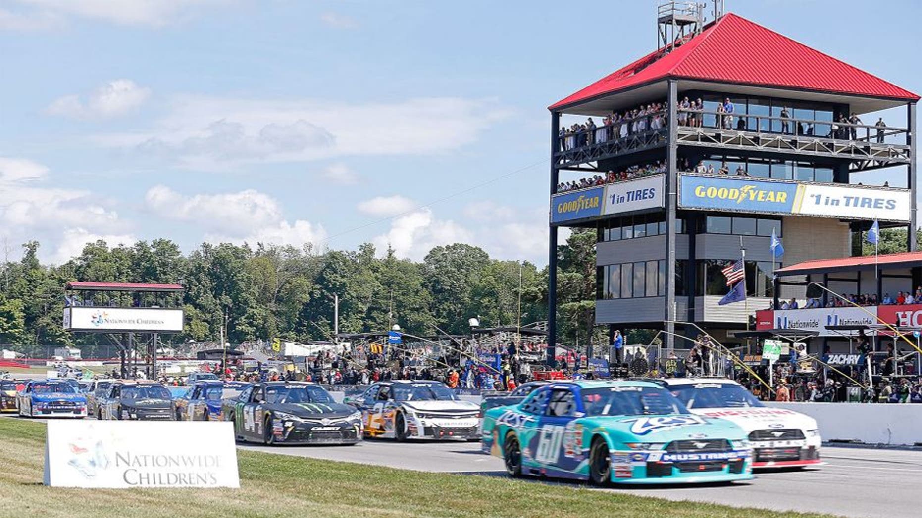 LEXINGTON, OH - AUGUST 15: Chris Buescher, driver of the #60 Zest Ford, and Alex Tagliani, driver of the #22 Discount Tire Ford, lead the field through the start/finish line for the start of the NASCAR Xfinity Nationwide Children's Hospital 200 at Mid-Ohio Sports Car Course on August 15, 2015 in Lexington, Ohio. Photo by Kirk Irwin/Getty Images)