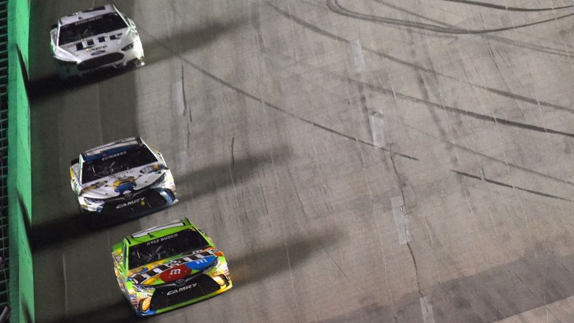 Kyle Busch, driver of the #18 M&M's Crispy Toyota, leads a pack of cars during the NASCAR Sprint Cup Series Quaker State 400 presented by Advance Auto Parts at Kentucky Speedway on July 11, 2015 in Sparta, Kentucky. (Photo by Jonathan Moore/Getty Images)