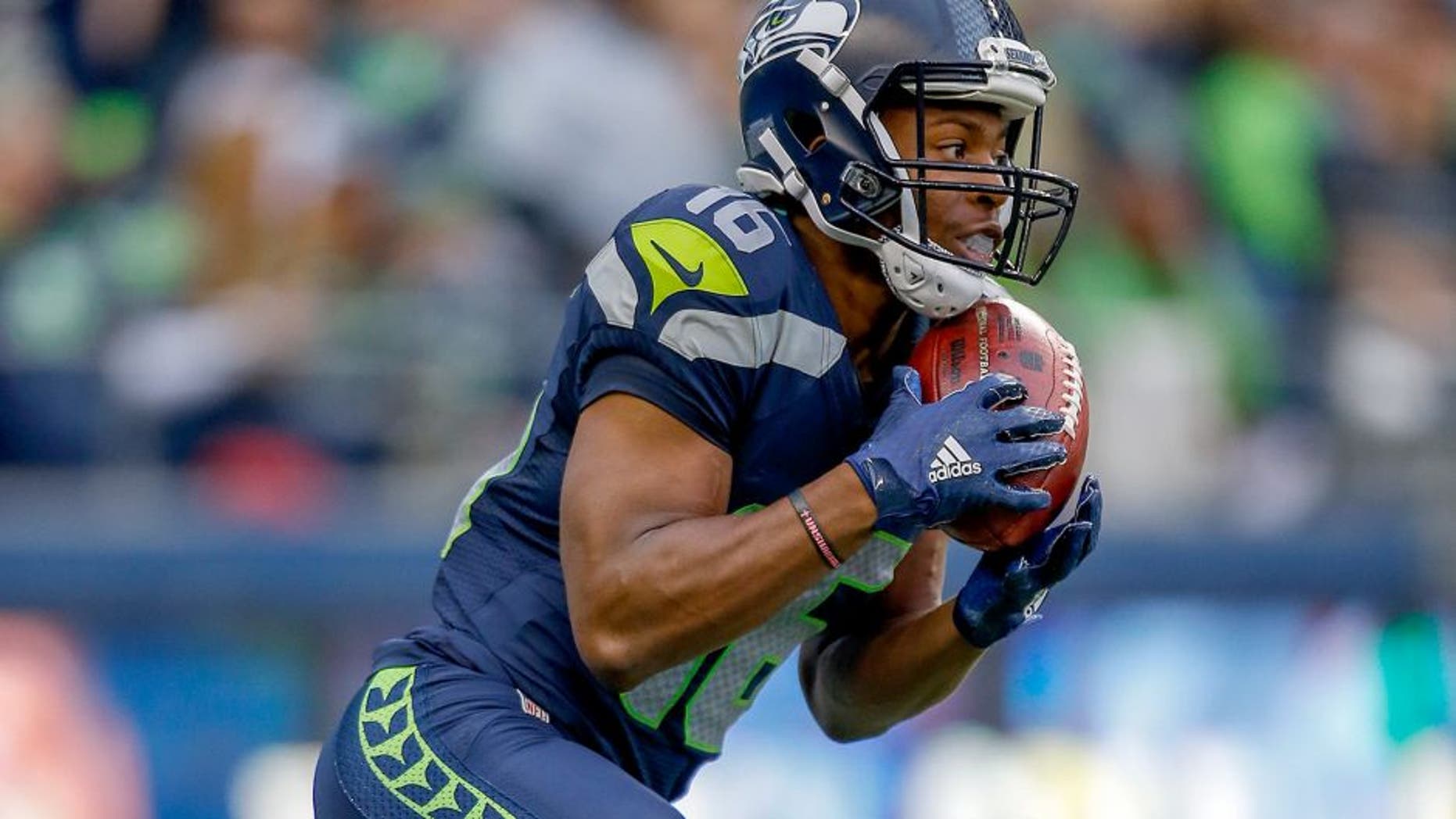 SEATTLE, WA - AUGUST 14: Kick returner Tyler Lockett #16 of the Seattle Seahawks returns a kickoff for a touchdown against the Denver Broncos at CenturyLink Field on August 14, 2015 in Seattle, Washington. (Photo by Otto Greule Jr/Getty Images)