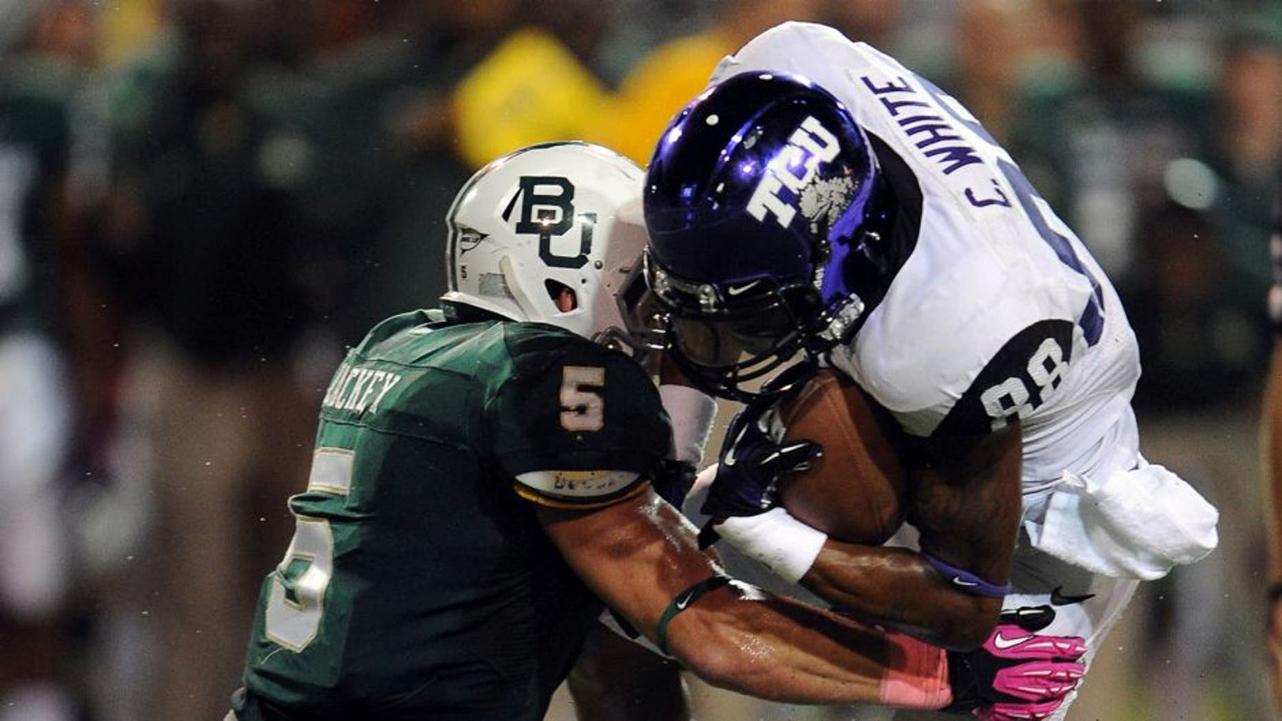 Oct 13, 2012; Waco, TX, USA; TCU Horned Frogs wide receiver Cam White (88) is tackled by Baylor Bears linebacker Eddie Lackey (5) during the third quarter at Floyd Casey Stadium. The Frogs defeated the Bears 49-21. Mandatory Credit: Jerome Miron-USA TODAY Sports