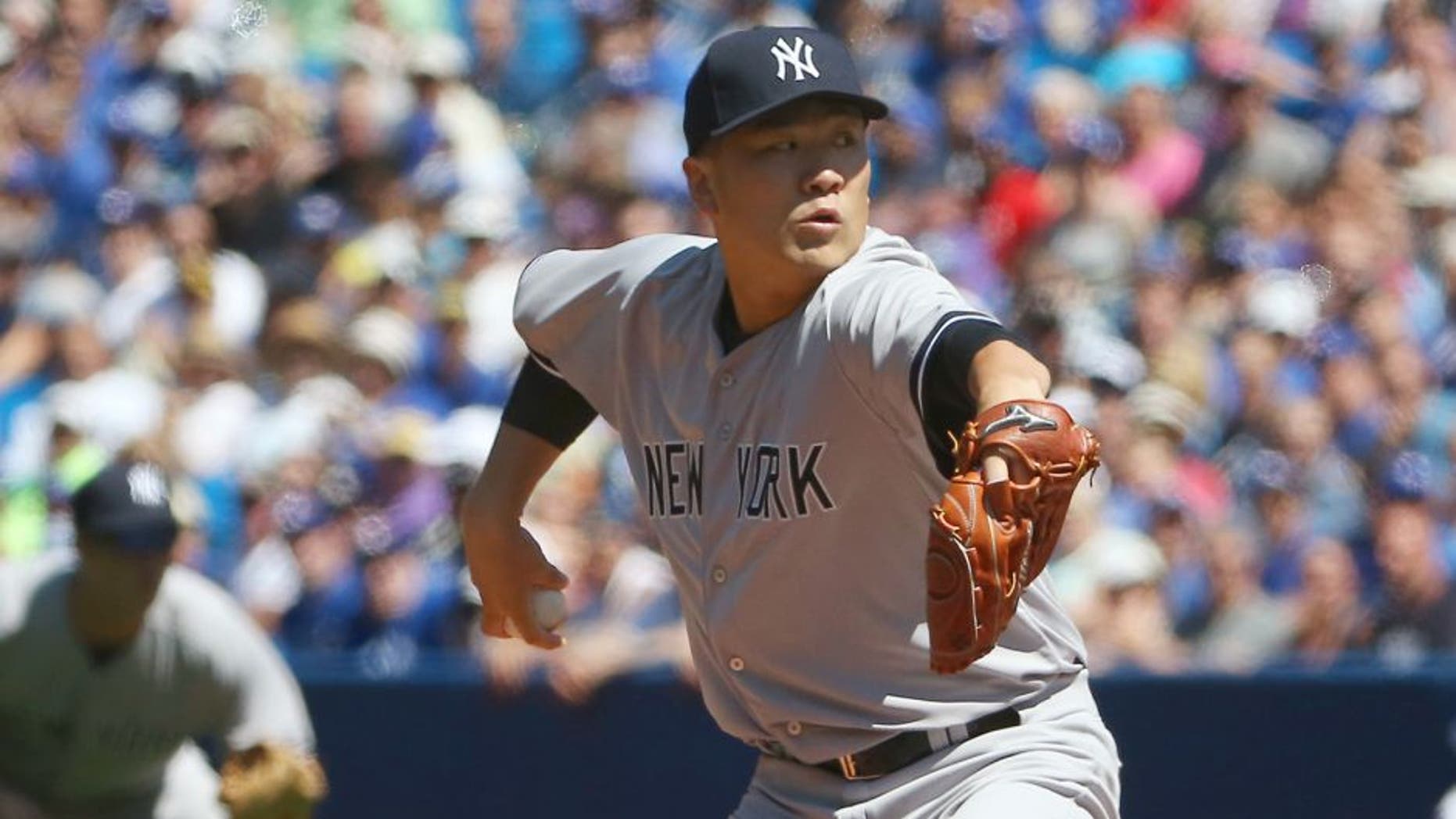 Masahiro Tanaka #19 of the New York Yankees delivers a pitch in the first inning during MLB game action against the Toronto Blue Jays on August 15, 2015 at Rogers Centre in Toronto, Ontario, Canada. (Photo by Tom Szczerbowski/Getty Images)