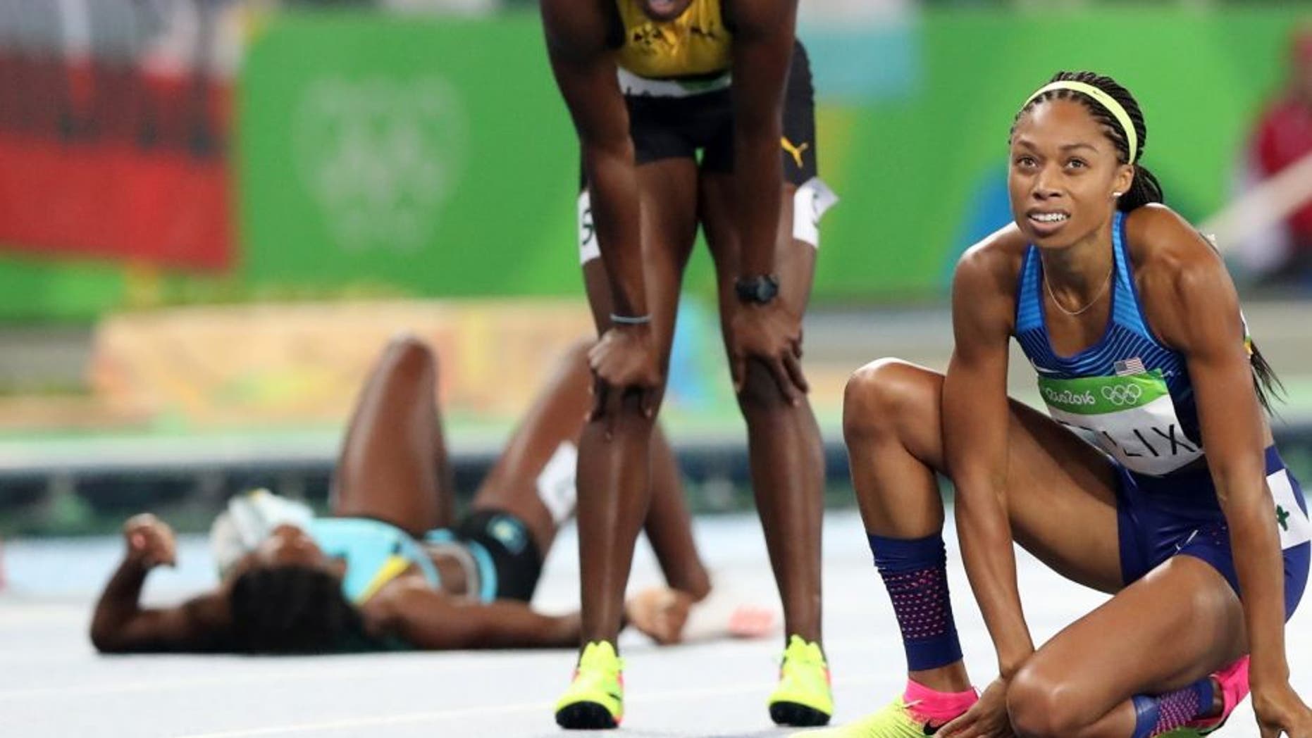 United States' Allyson Felix, right, looks at the scoreboard after the women's 400-meter final during the athletics competitions of the 2016 Summer Olympics at the Olympic stadium in Rio de Janeiro, Brazil, Monday, Aug. 15, 2016. (AP Photo/Lee Jin-man)