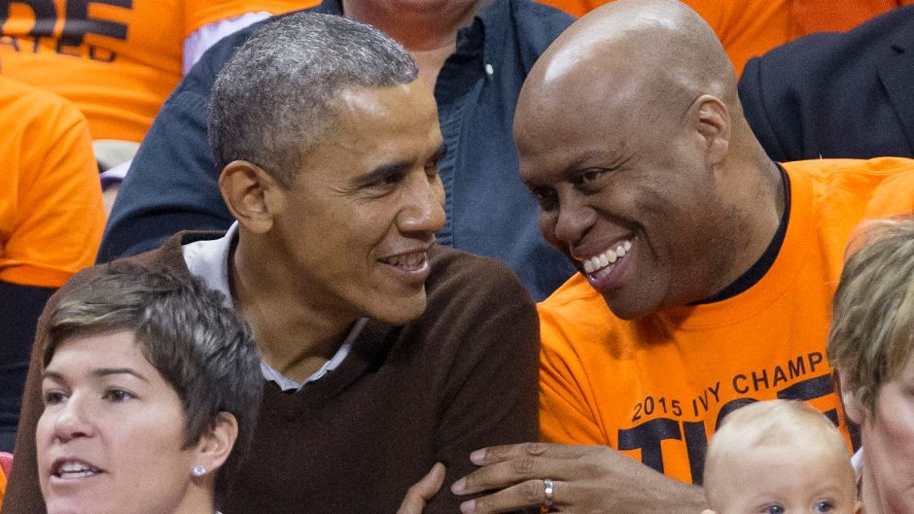 COLLEGE PARK, MD - MARCH 21: (AFP OUT) U.S. President Barack Obama (L) sits beside his brother-in-law Craig Robinson while attending the Green Bay versus Princeton women's college basketball game in the first round of the NCAA tournament, March 21, 2015 in College Park, Maryland. President Barack Obama's niece Leslie Robinson plays for Princeton. (Photo by MIchael Reynolds-Pool/Getty Images)