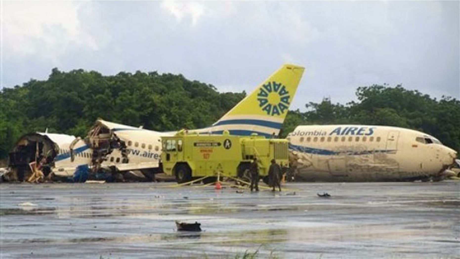 Aug. 16: A plane that crashed lays in pieces along the runaway at the airport on San Andres island in Colombia. The Boeing 737 operated by the airline Aires crashed on landing after departing from Bogota around midnight local time with 131 passengers (AP).