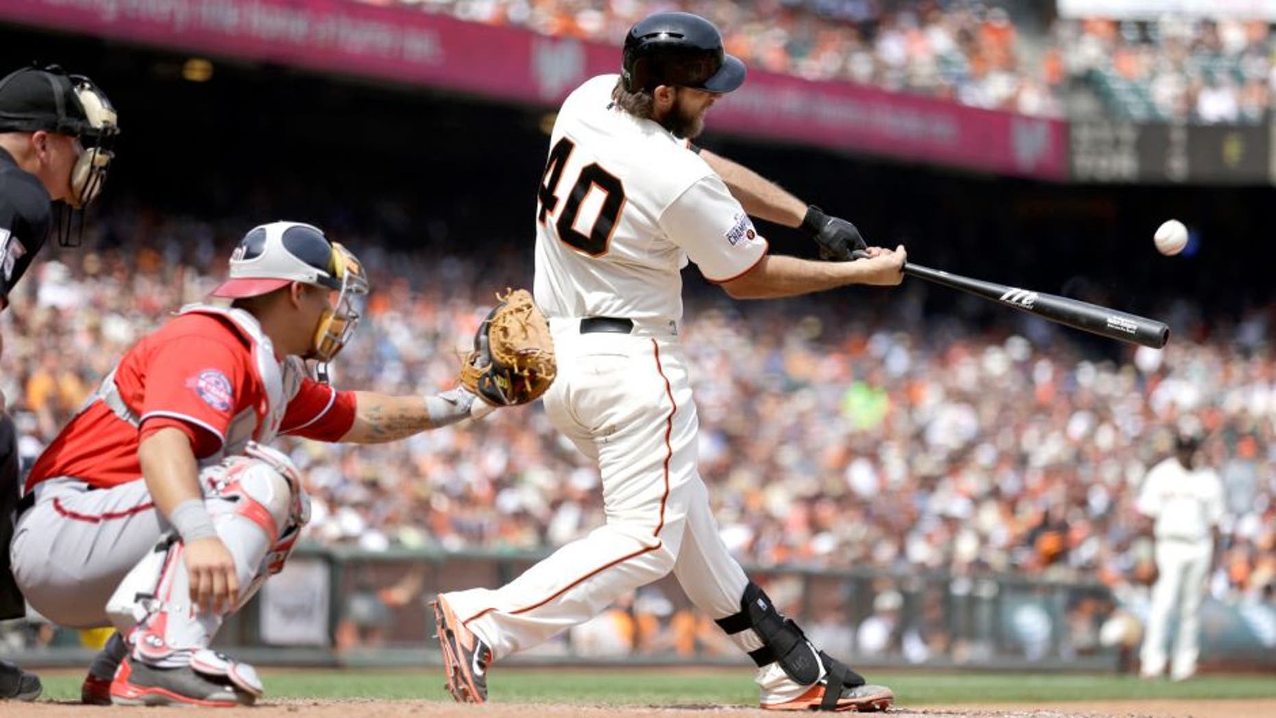 San Francisco Giants' Madison Bumgarner (40) swings for a home run off Washington Nationals' Casey Janssen in the seventh inning of a baseball game Sunday, Aug. 16, 2015, in San Francisco. (AP Photo/Ben Margot)