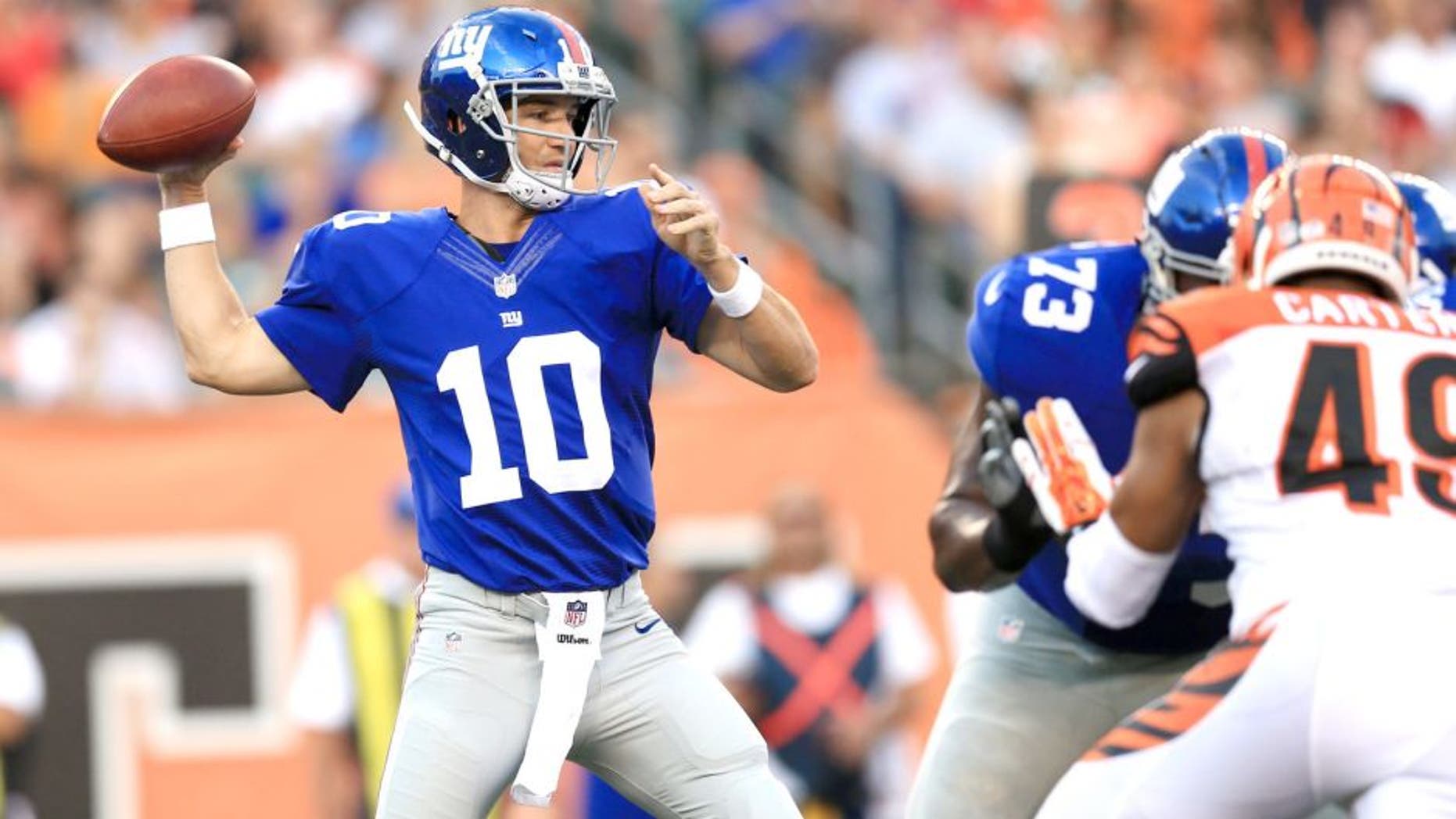 Aug 14, 2015; Cincinnati, OH, USA; New York Giants quarterback Eli Manning (10) throws a pass during the first quarter of a preseason NFL football game against the Cincinnati Bengals at Paul Brown Stadium. Mandatory Credit: Andrew Weber-USA TODAY Sports