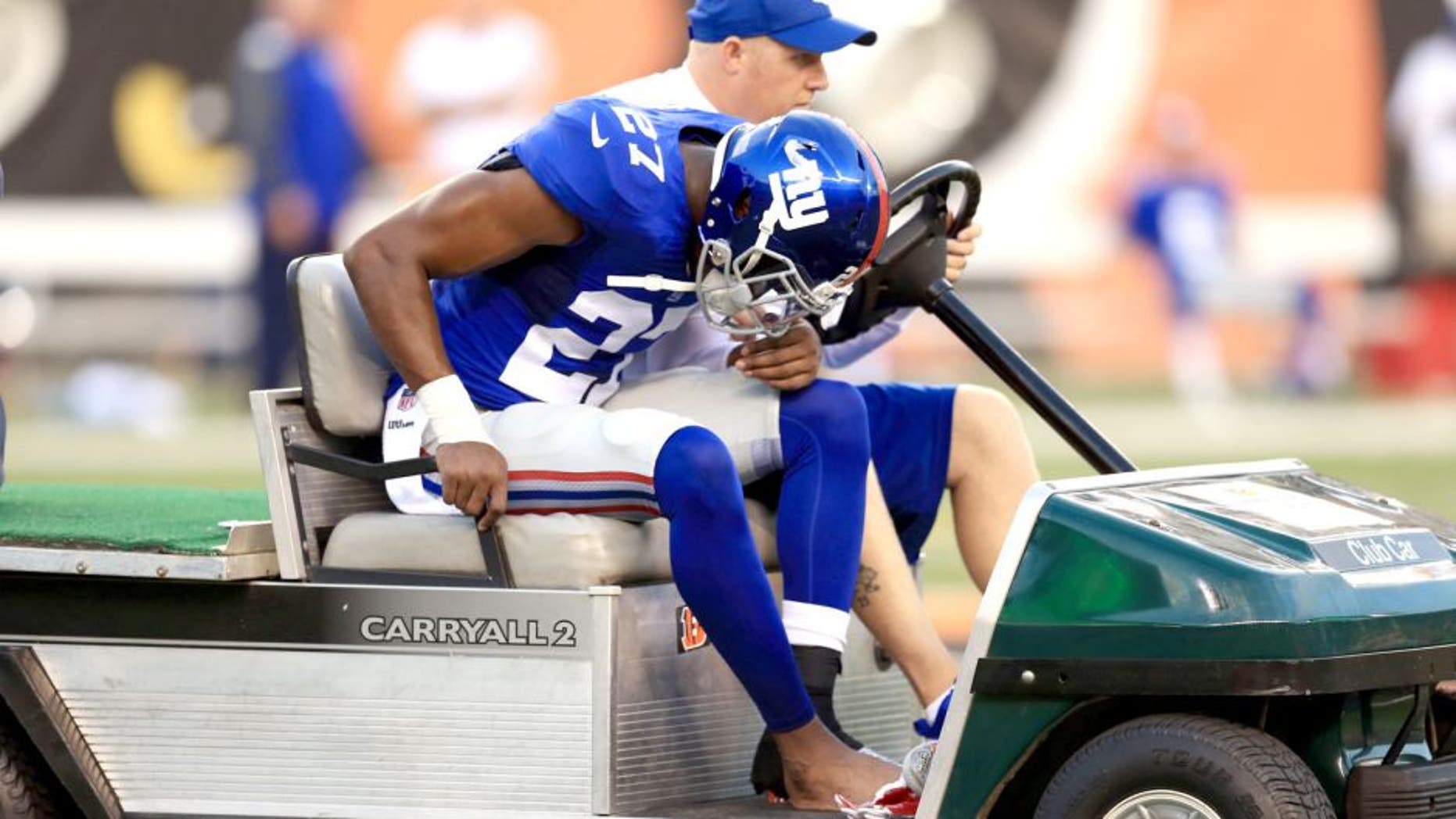 Aug 14, 2015; Cincinnati, OH, USA; New York Giants safety Mykkele Thompson (27) is attended to after an injury during the second quarter of a preseason NFL football game against the Cincinnati Bengals at Paul Brown Stadium. Mandatory Credit: Andrew Weber-USA TODAY Sports