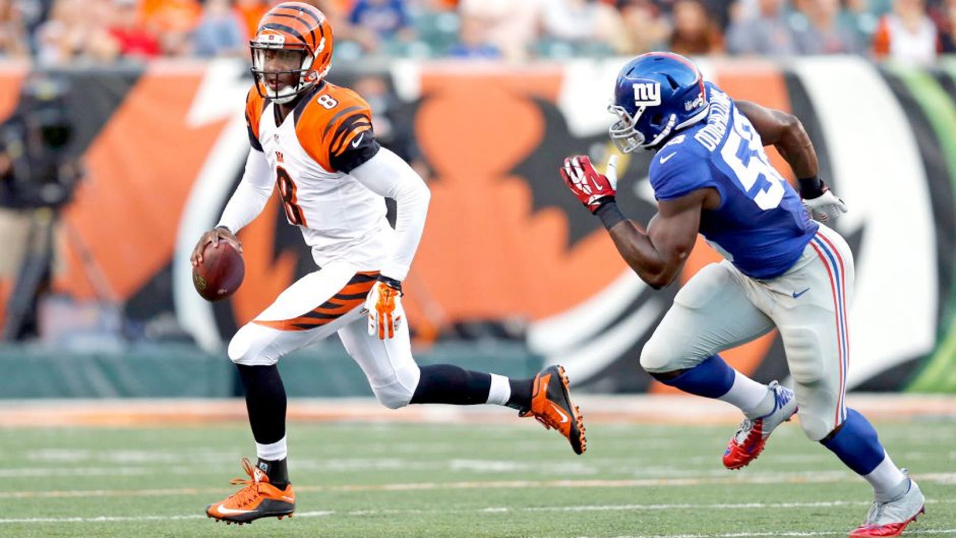 New York Giants defensive end Owamagbe Odighizuwa (58) chases Cincinnati Bengals quarterback Josh Johnson during the first half of an NFL preseason football game in Cincinnati, Friday, Aug. 14, 2015. (AP Photo/Gary Landers)