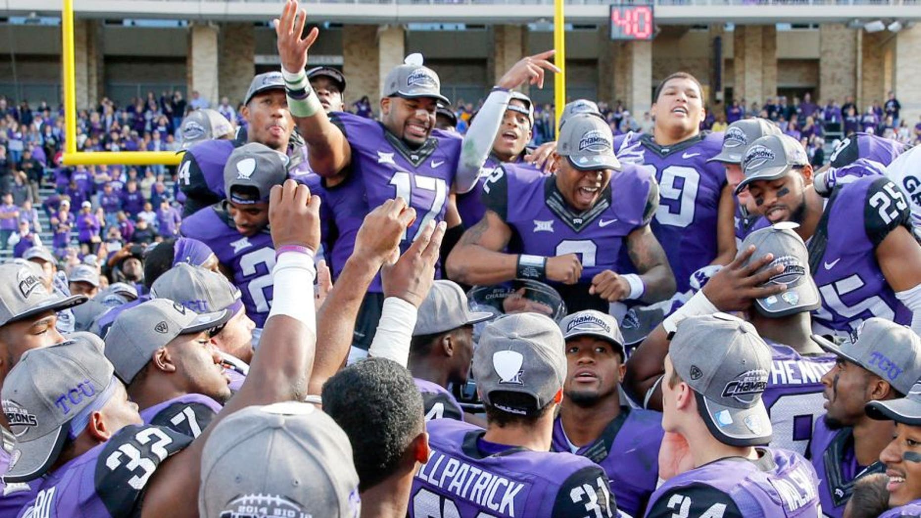 Dec 6, 2014; Fort Worth, TX, USA; TCU Horned Frogs quarterback Trevone Boykin (2) and safety Sam Carter (17) and teammates celebrate after the victory against the Iowa State Cyclones at Amon G. Carter Stadium. Mandatory Credit: Kevin Jairaj-USA TODAY Sports