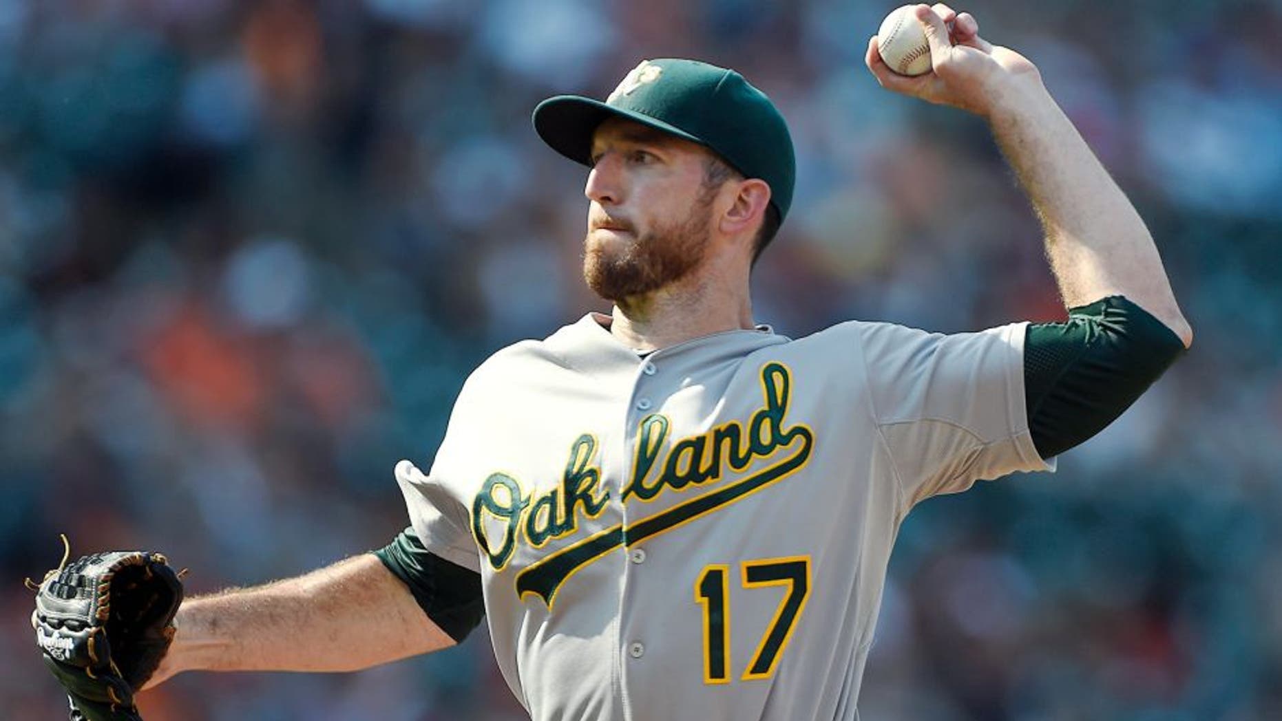 Aug 16, 2015; Baltimore, MD, USA; Oakland Athletics first baseman Ike Davis (17) pitches during the eighth inning against the Baltimore Orioles at Oriole Park at Camden Yards. The Orioles won 18-2. Mandatory Credit: Tommy Gilligan-USA TODAY Sports