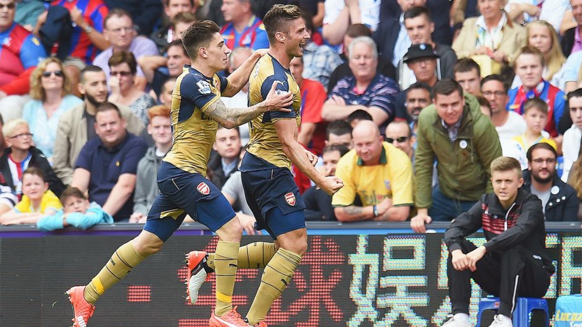 LONDON, ENGLAND - AUGUST 16: Olivier Giroud (R) of Arsenal celebrates scoring the opening goal with team mate Hector Bellerin during the Barclays Premier League match between Crystal Palace and Arsenal at Selhurst Park on August 16, 2015 in London, England. (Photo by Michael Regan/Getty Images)