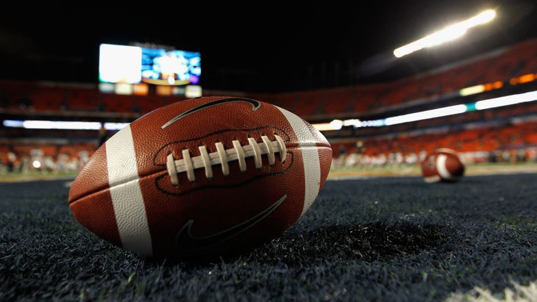 MIAMI GARDENS, FL - JANUARY 04: A detail of a Nike official NCAA size football as it sits in the end zone while the West Virginia Mountaineers stretchon the field prior to playing against the Clemson Tigers during the Discover Orange Bowl at Sun Life Stadium on January 4, 2012 in Miami Gardens, Florida. (Photo by Streeter Lecka/Getty Images)