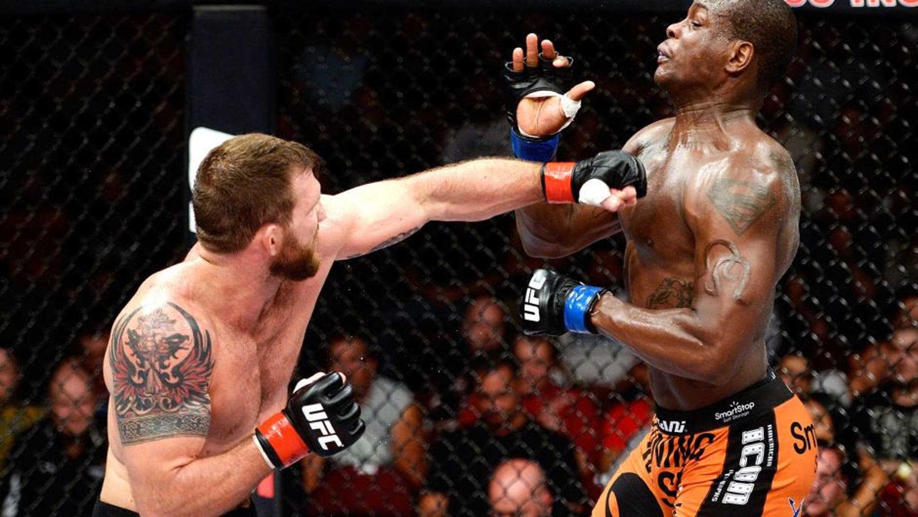 BANGOR, ME - AUGUST 16: (L-R) Ryan Bader punches Ovince Saint Preux in their light heavyweight bout during the UFC fight night event at the Cross Insurance Center on August 16, 2014 in Bangor, Maine. (Photo by Jeff Bottari/Zuffa LLC/Zuffa LLC via Getty Images)