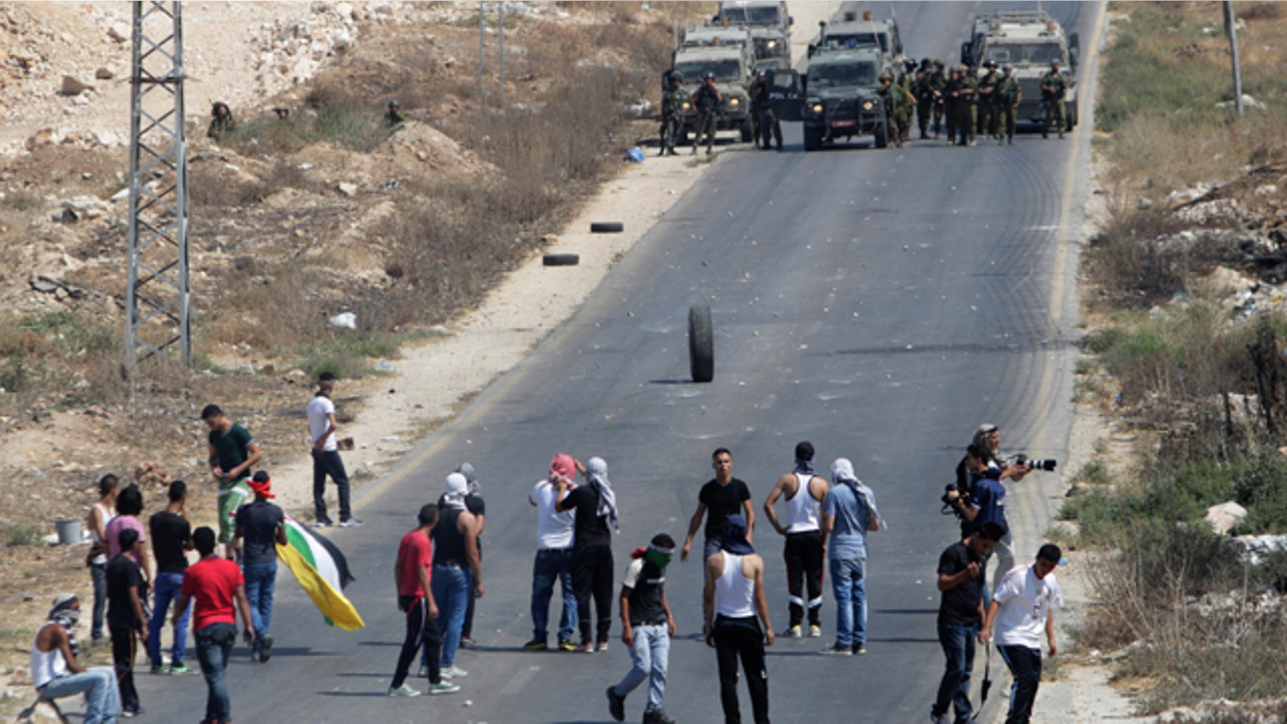 August 15, 2014: Palestinian protesters face Israeli soldiers during clashes near the West Bank city of Nablus. (AP)