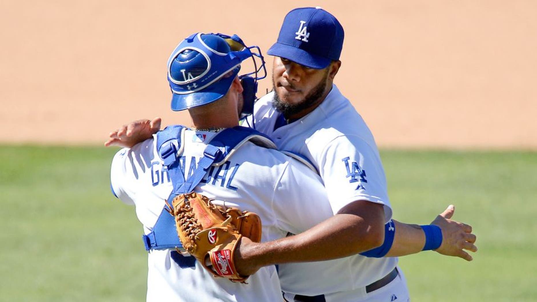 LOS ANGELES, CA - AUGUST 16: Closer Kenley Jansen #74 and catcher Yasmani Grandal #9 of the Los Angeles Dodgers celebrate after defeating the Cincinnati Reds, 2-1, at Dodger Stadium August 16, 2015, in Los Angeles, California. (Photo by Kevork Djansezian/Getty Images)