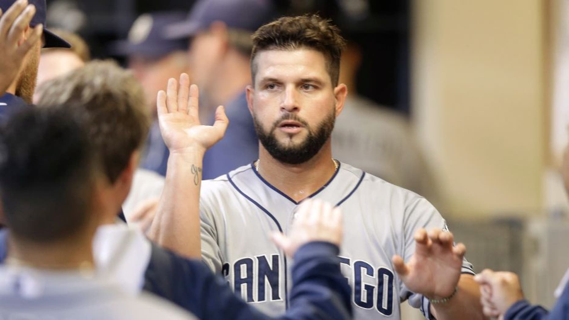 MILWAUKEE, WI - AUGUST 05: Yonder Alonso #23 of the San Diego Padres celebrates after reach home plate on a RBI single hit by Will Venable in the seventh inning against the Milwaukee Brewers at Miller Park on August 05, 2015 in Milwaukee, Wisconsin. (Photo by Mike McGinnis/Getty Images)