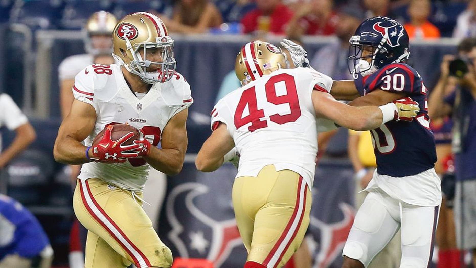 HOUSTON, TX - AUGUST 15: Jarryd Hayne #38 of the San Francisco 49ers rushes with the ball as he gets a block from Bruce Miller #49 on Kevin Johnson #30 of the Houston Texans during a preseason football game at NRG Stadium on August 15, 2015 in Houston, Texas. Houston won 23-10. (Photo by Bob Levey/Getty Images)