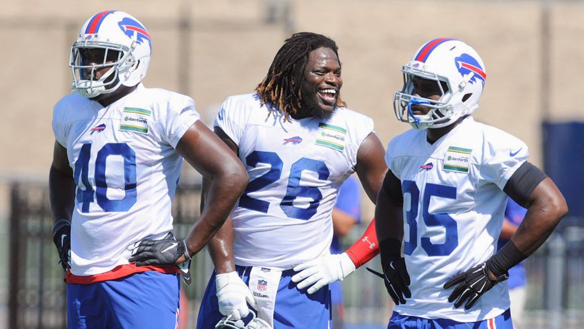 Jul 31, 2015; Pittsford, NY, USA; Buffalo Bills running back Anthony Dixon (26) speaks with Karlos Williams (40) and Bryce Brown (35) during training camp at St. John Fisher College. Mandatory Credit: Mark Konezny-USA TODAY Sports