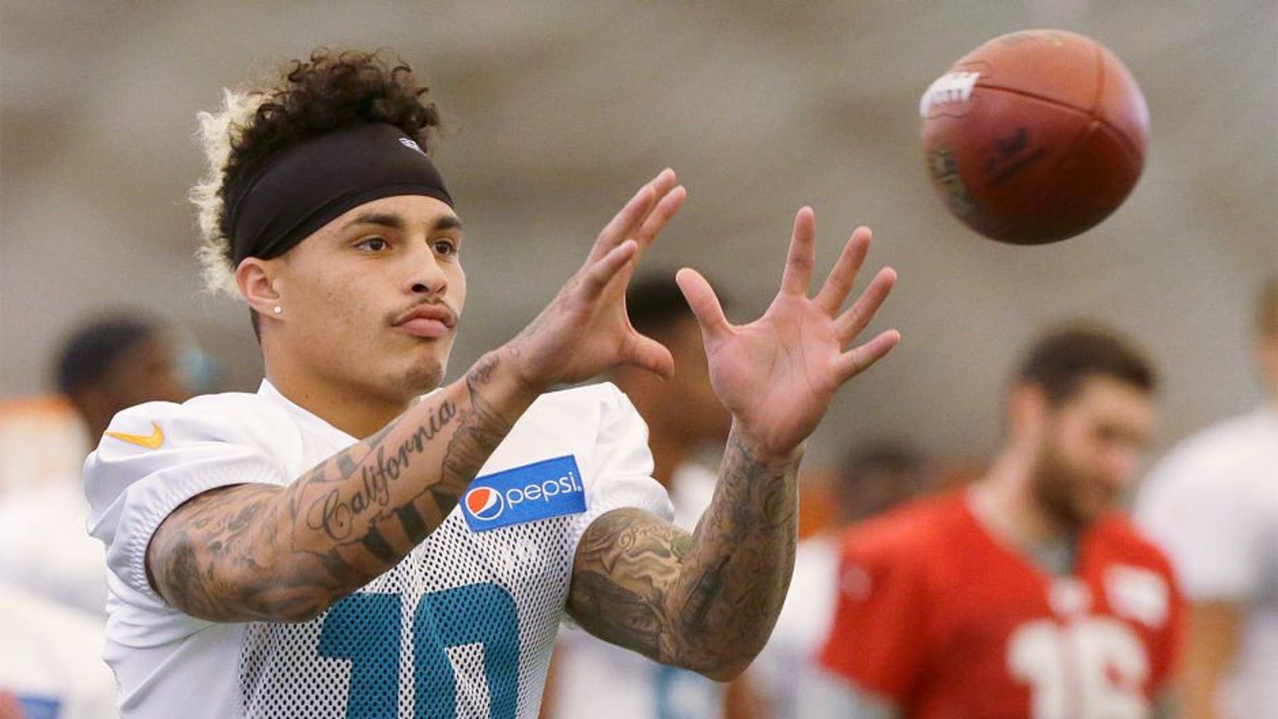 Miami Dolphins wide receiver Kenny Stills catches the ball as he warms up during an NFL football training camp practice, Monday, Aug. 10, 2015 in Davie, Fla. (AP Photo/Wilfredo Lee)