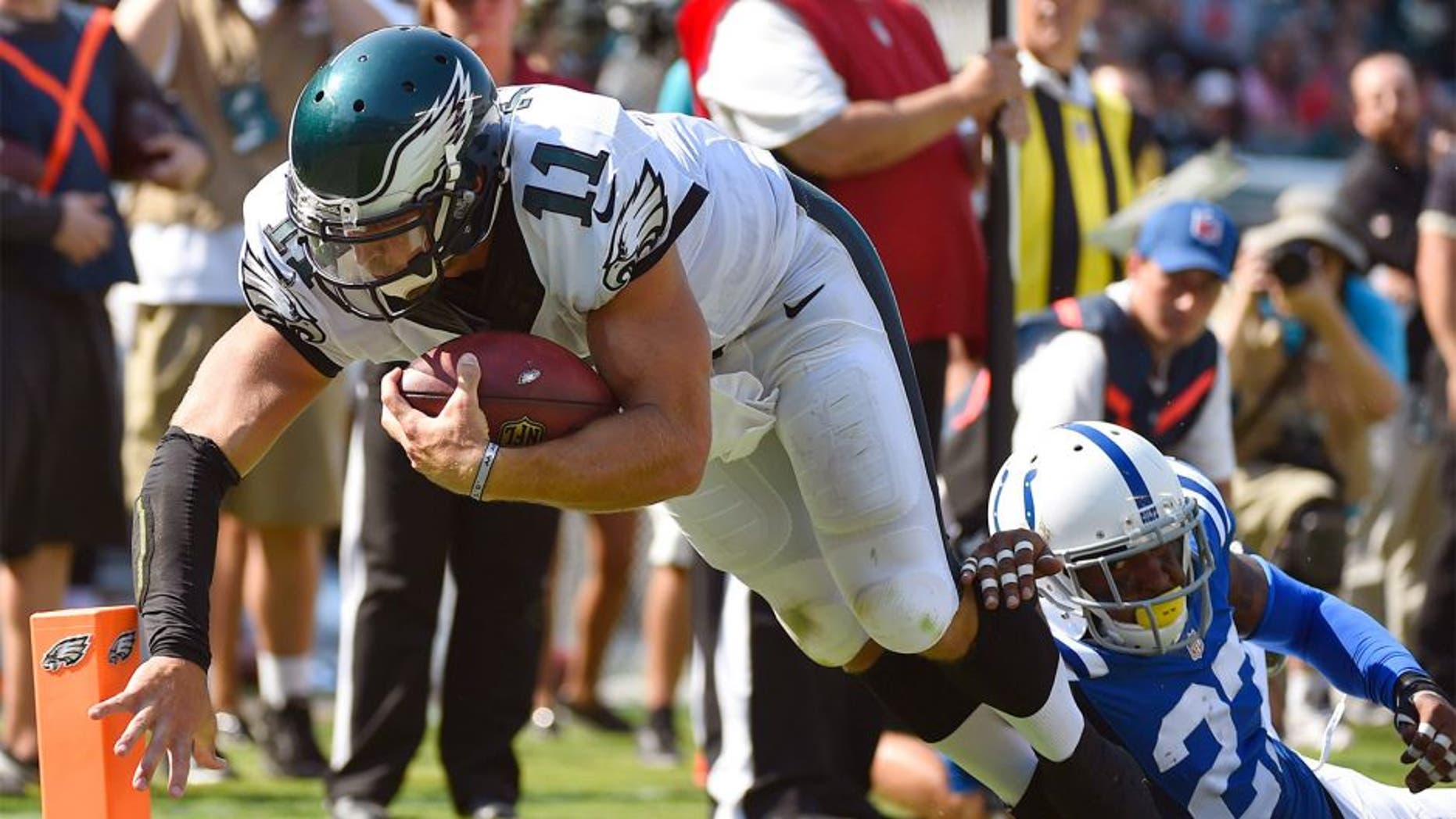 Aug 16, 2015; Philadelphia, PA, USA; Philadelphia Eagles quarterback Tim Tebow (11) dives into the end zone past Indianapolis Colts free safety Winston Guy (27) to score a touchdown during the second half of a preseason NFL football game at Lincoln Financial Field. The Eagles won 36-10. Mandatory Credit: Derik Hamilton-USA TODAY Sports