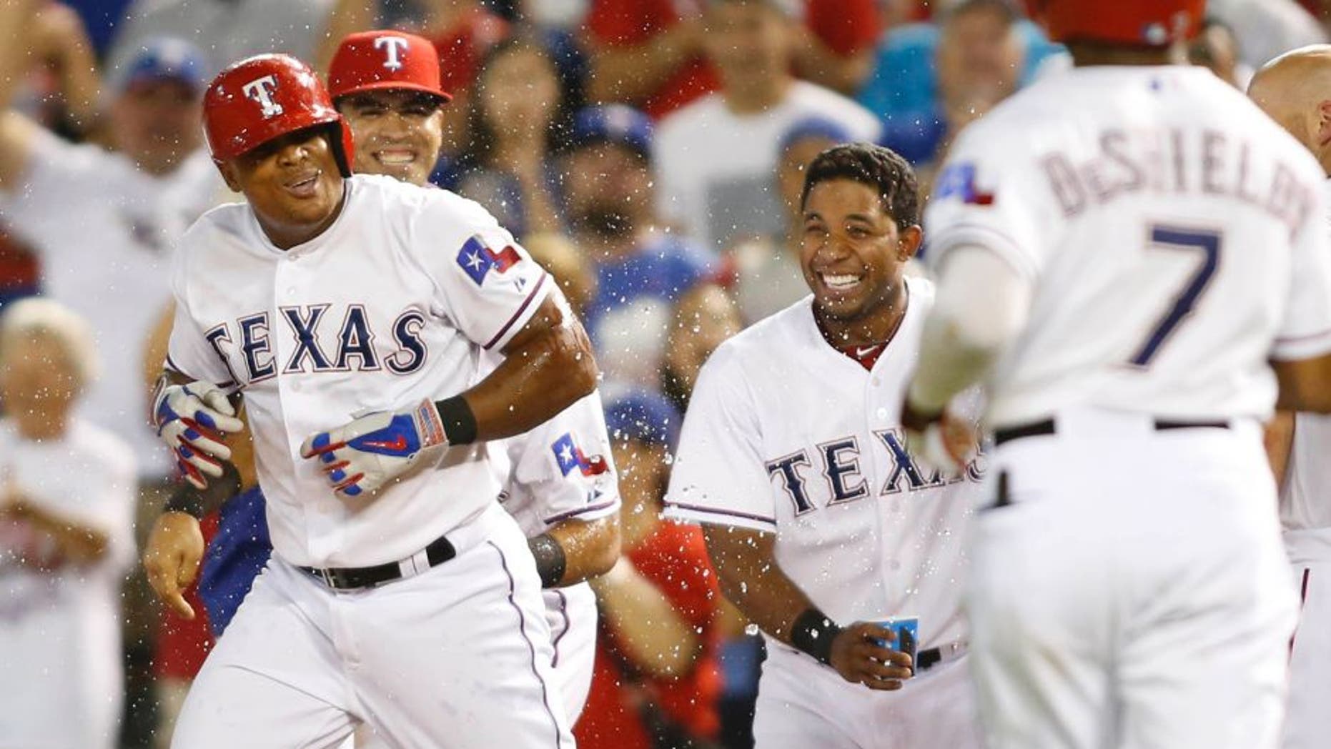 Aug 17, 2015; Arlington, TX, USA; Texas Rangers third baseman Adrian Beltre (29) is splashed with water after winning the game in the bottom of the ninth inning with a walk against Seattle Mariners relief pitcher Fernando Rodney (not pictured) at Globe Life Park in Arlington. Texas won 4-3. Mandatory Credit: Tim Heitman-USA TODAY Sports