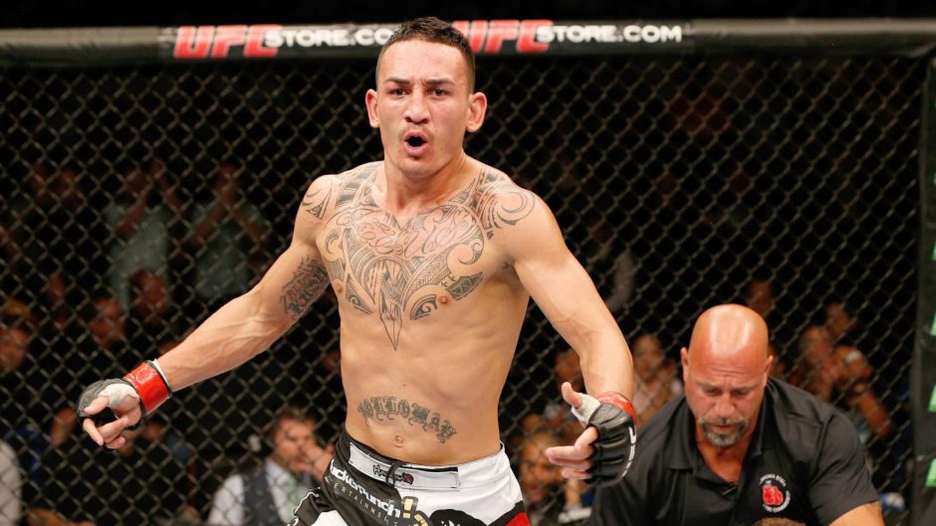 TULSA, OK - AUGUST 23: Max Holloway celebrates after his victory over Clay Collard in their featherweight fight during the UFC Fight Night event at the BOK Center on August 23, 2014 in Tulsa, Oklahoma. (Photo by Josh Hedges/Zuffa LLC/Zuffa LLC via Getty Images)
