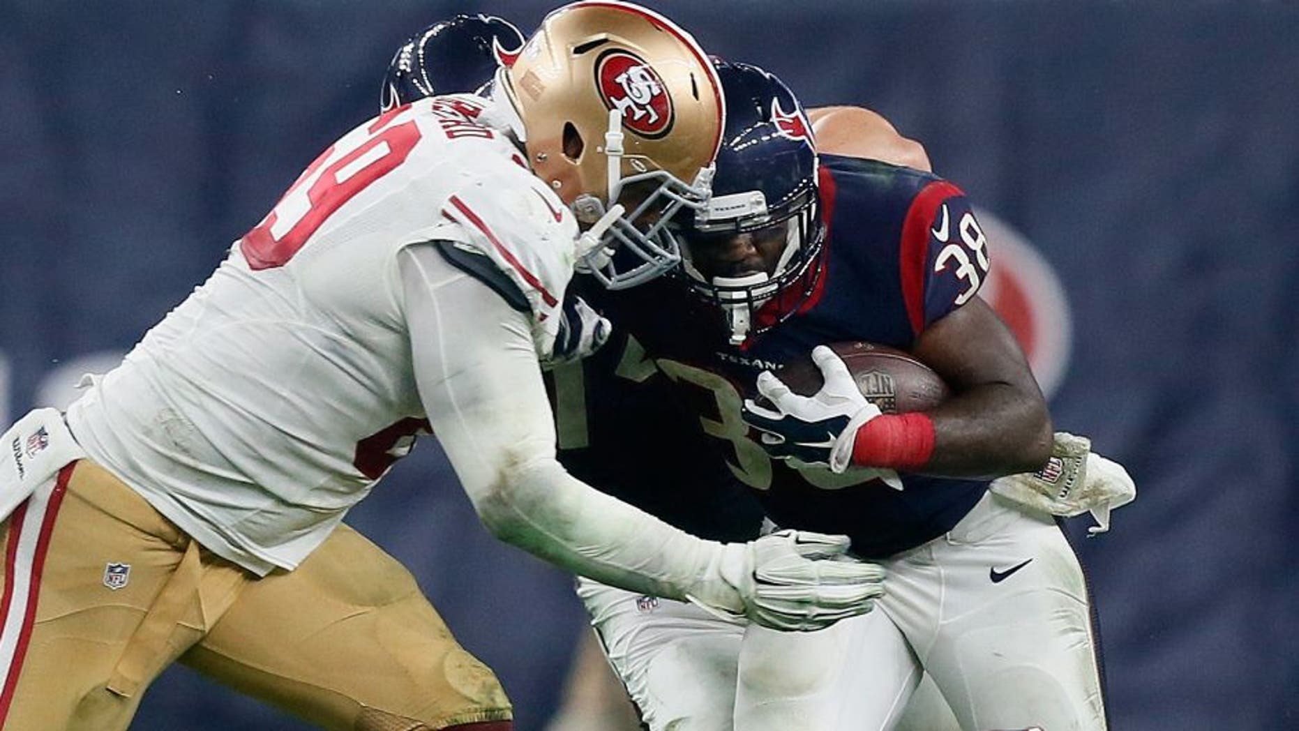HOUSTON, TX - AUGUST 15: Kenny Hilliard #38 of the Houston Texans is tackled by Arik Armstead #69 of the San Francisco 49ers at Reliant Arena at Reliant Park on August 15, 2015 in Houston, Texas. (Photo by Bob Levey/Getty Images)