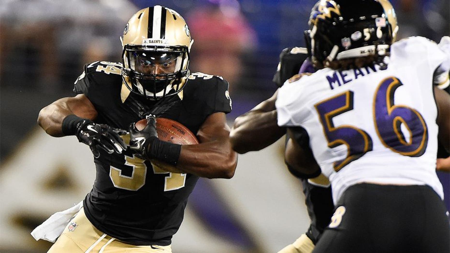 Aug 13, 2015; Baltimore, MD, USA; New Orleans Saints running back Tim Hightower (34) runs with the ball during the third quarter against the Baltimore Ravens in a preseason NFL football game at M&T Bank Stadium. Mandatory Credit: Tommy Gilligan-USA TODAY Sports