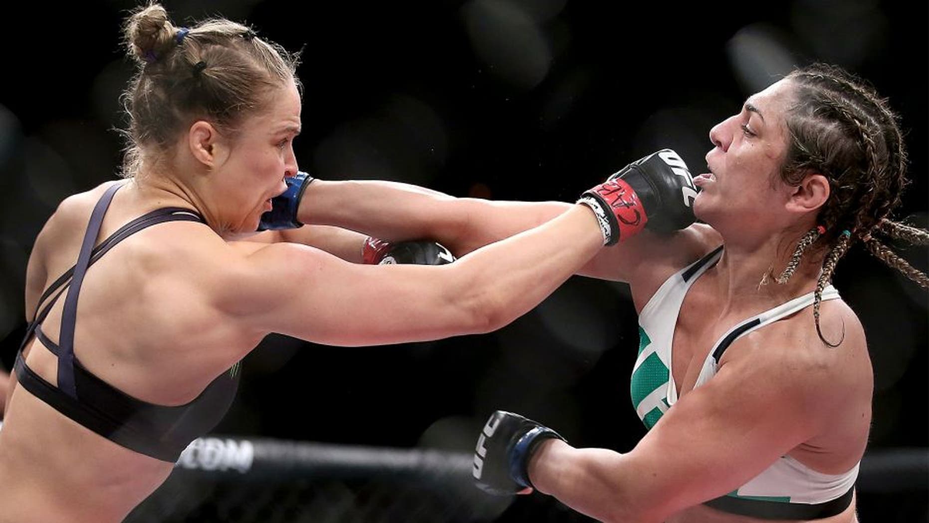 RIO DE JANEIRO, BRAZIL - AUGUST 01: Ronda Rousey of the United States (red) fights Bethe Correia of Brazi (blue) l in their bantamweight title fight during the UFC 190 Rousey v Correia at HSBC Arena on August 1, 2015 in Rio de Janeiro, Brazil. (Photo by Matthew Stockman/Getty Images)