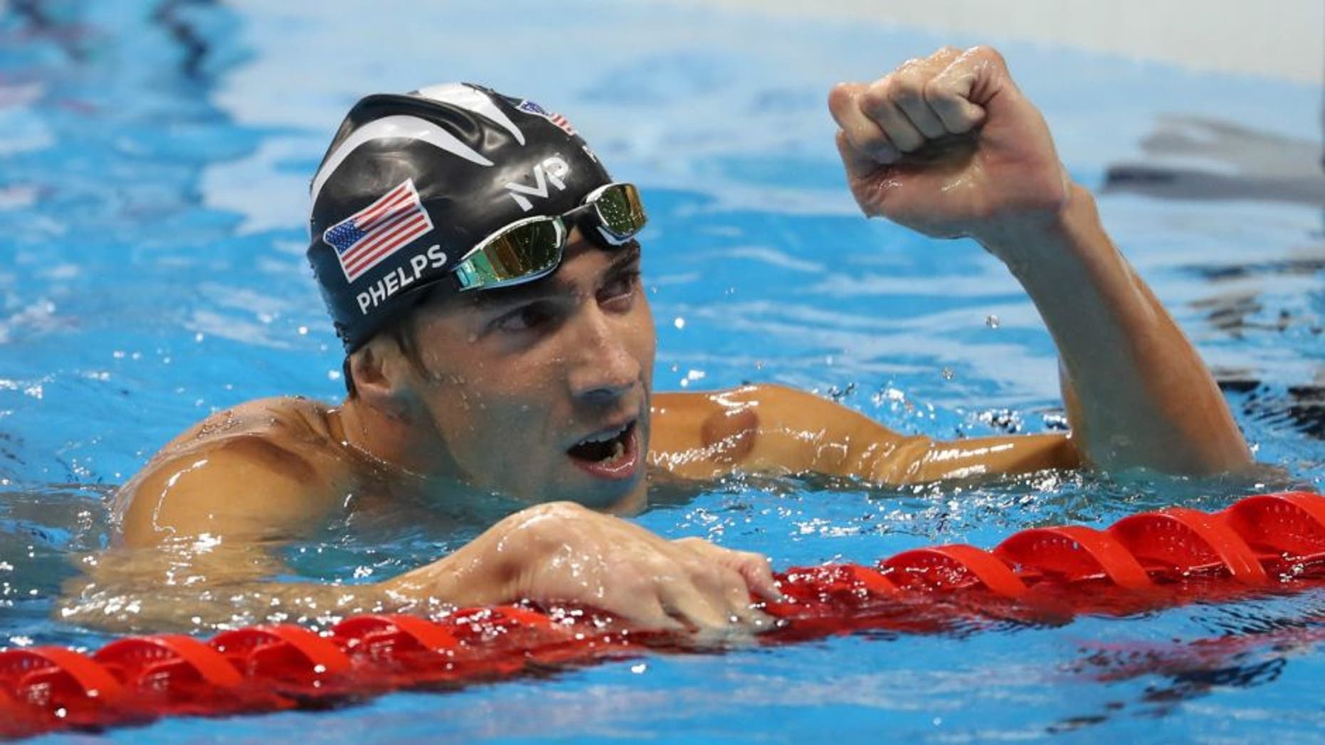Aug 9, 2016; Rio de Janeiro, Brazil; Michael Phelps (USA) reacts after winning the men's 200m butterfly final in the Rio 2016 Summer Olympic Games at Olympic Aquatics Stadium. Mandatory Credit: Jason Getz-USA TODAY Sports