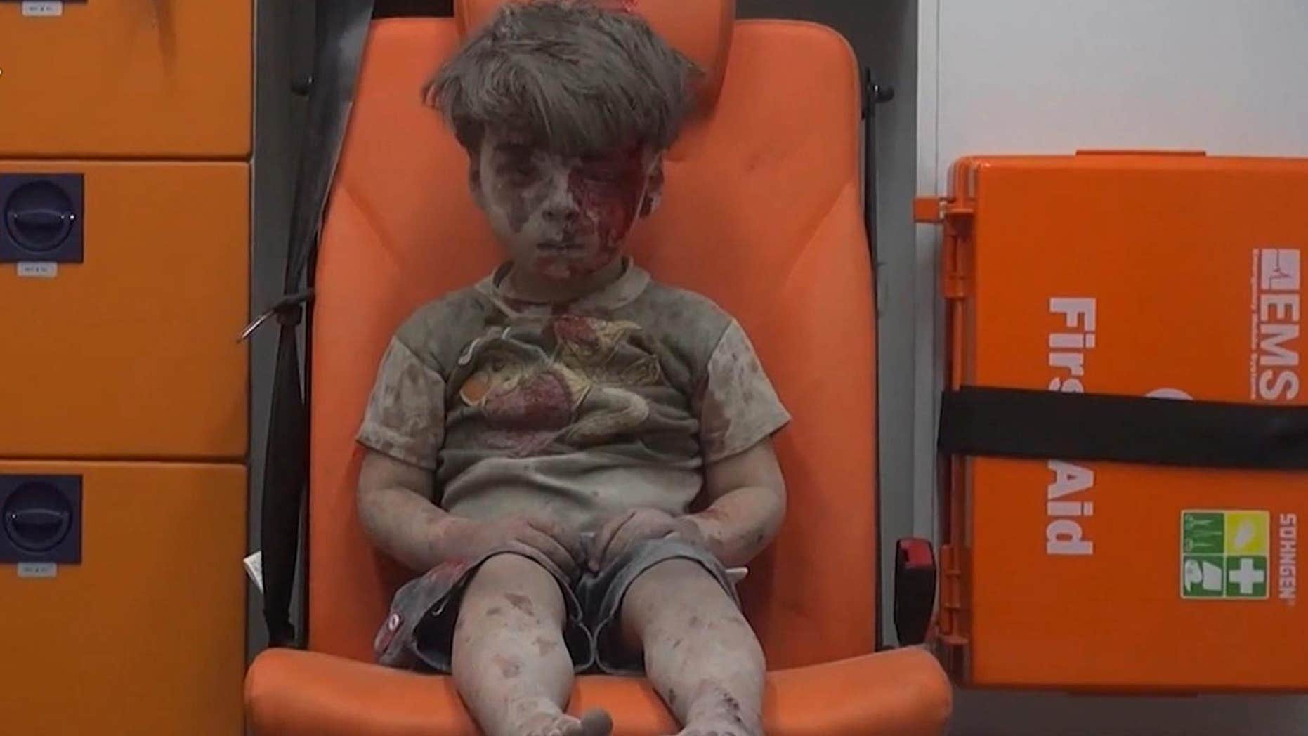 Aug. 17, 2016: In this frame grab taken from video provided by the Syrian anti-government activist group Aleppo Media Center (AMC), a child sits in an ambulance after being pulled out or a building hit by an airstirke, in Aleppo, Syria.