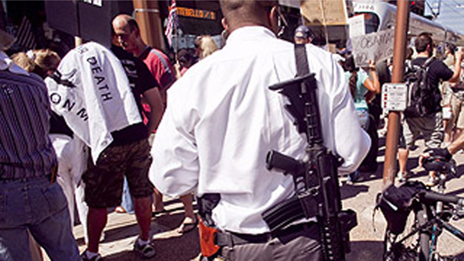 Aug. 17: A man carries a military style AR-15 rifle during an Obama opposition rally in Phoenix.
