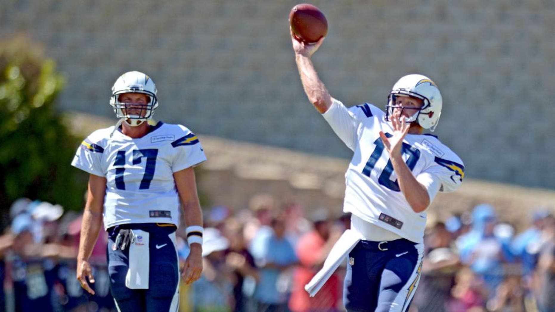 Aug 5, 2015; San Diego, CA, USA; San Diego Chargers quarterback Kellen Clemens (10) passes as quarterback Philip Rivers (17) looks on during minicamp at Chargers Park. Mandatory Credit: Jake Roth-USA TODAY Sports