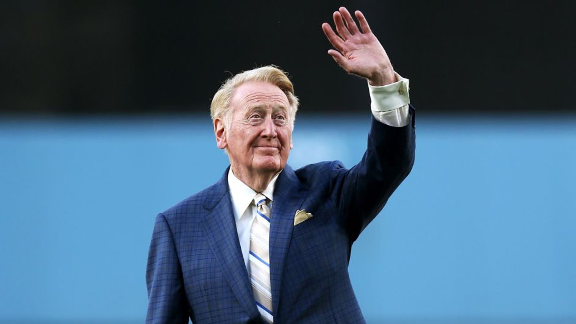 LOS ANGELES, CA - AUGUST 30: Dodger broadcaster Vin Scully waves to the crowd before throwing out the first pitch during ceeremoniew honoring him on his 64 years of sevice before the game between the Arizona Diamondbacks and the Los Angeles Dodgers on August 30, 2012 at Dodger Stadium in Los Angeles, California. (Photo by Stephen Dunn/Getty Images)