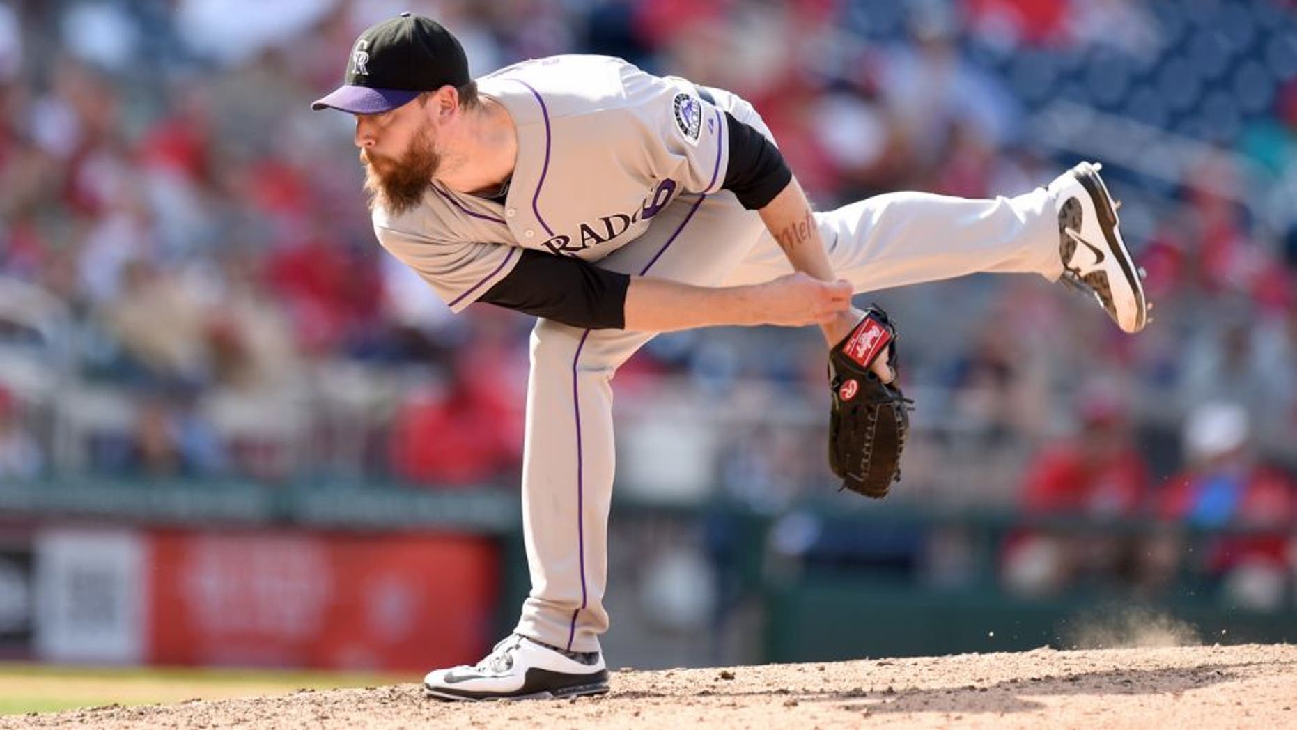 WASHINGTON, DC - AUGUST 09: John Axford #66 of the Colorado Rockies pitches in the eighth inning and get credit for the win during a baseball game against the Washington Nationals at Nationals Park on August 9, 2015 in Washington, DC. The Rockies won 6-4. (Photo by Mitchell Layton/Getty Images)