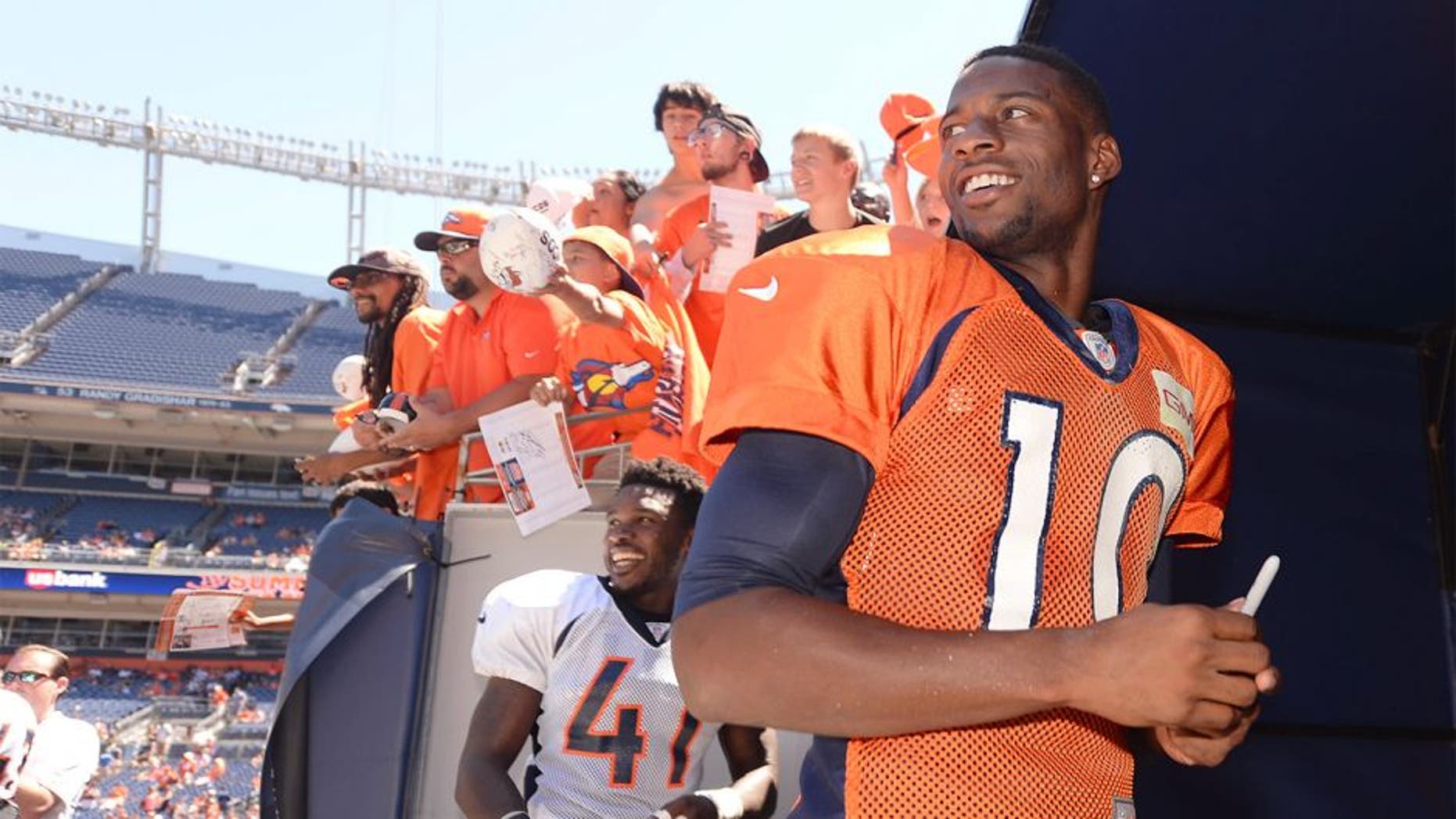 Aug 2, 2014; Denver, CO, USA; Denver Broncos wide receiver Emmanuel Sanders (10) leaves the field following a scrimmage at Sports Authority Field. Mandatory Credit: Ron Chenoy-USA TODAY Sports