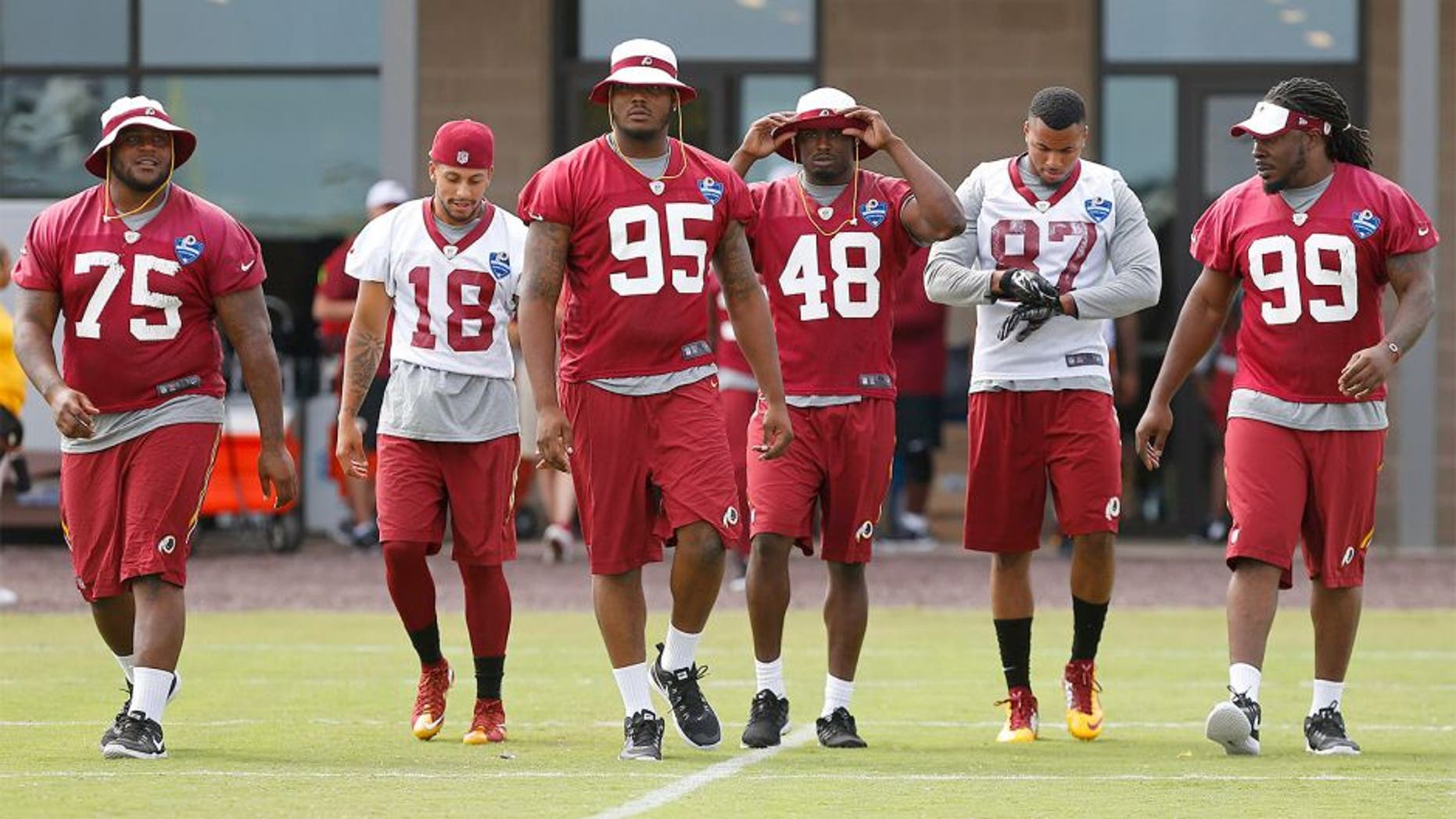 Jul 30, 2015; Richmond, VA, USA; Washington Redskins defensive end Corey Crawford (95) and Redskins defensive tackle Ricky Jean Francois (99) lead a group of teammates onto the field prior to the morning walkthrough on day one of training camp at the Washington Redskins Bon Secours Training Center. Mandatory Credit: Geoff Burke-USA TODAY Sports